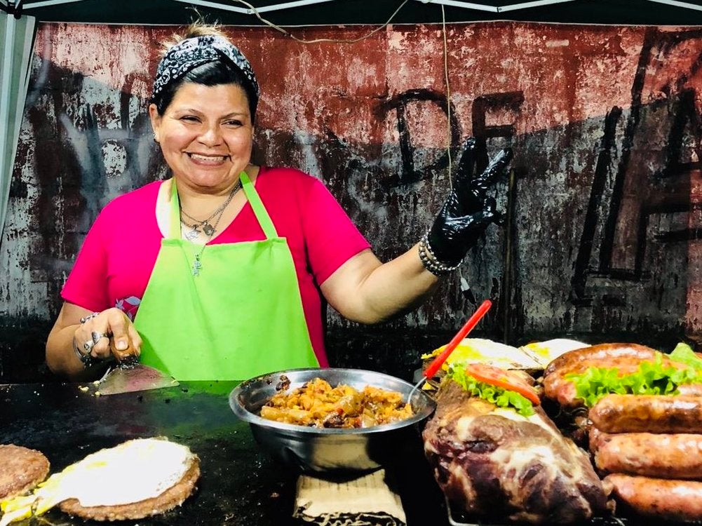 A vendor grills and sells choripans at Independiente, in Buenos Aires province