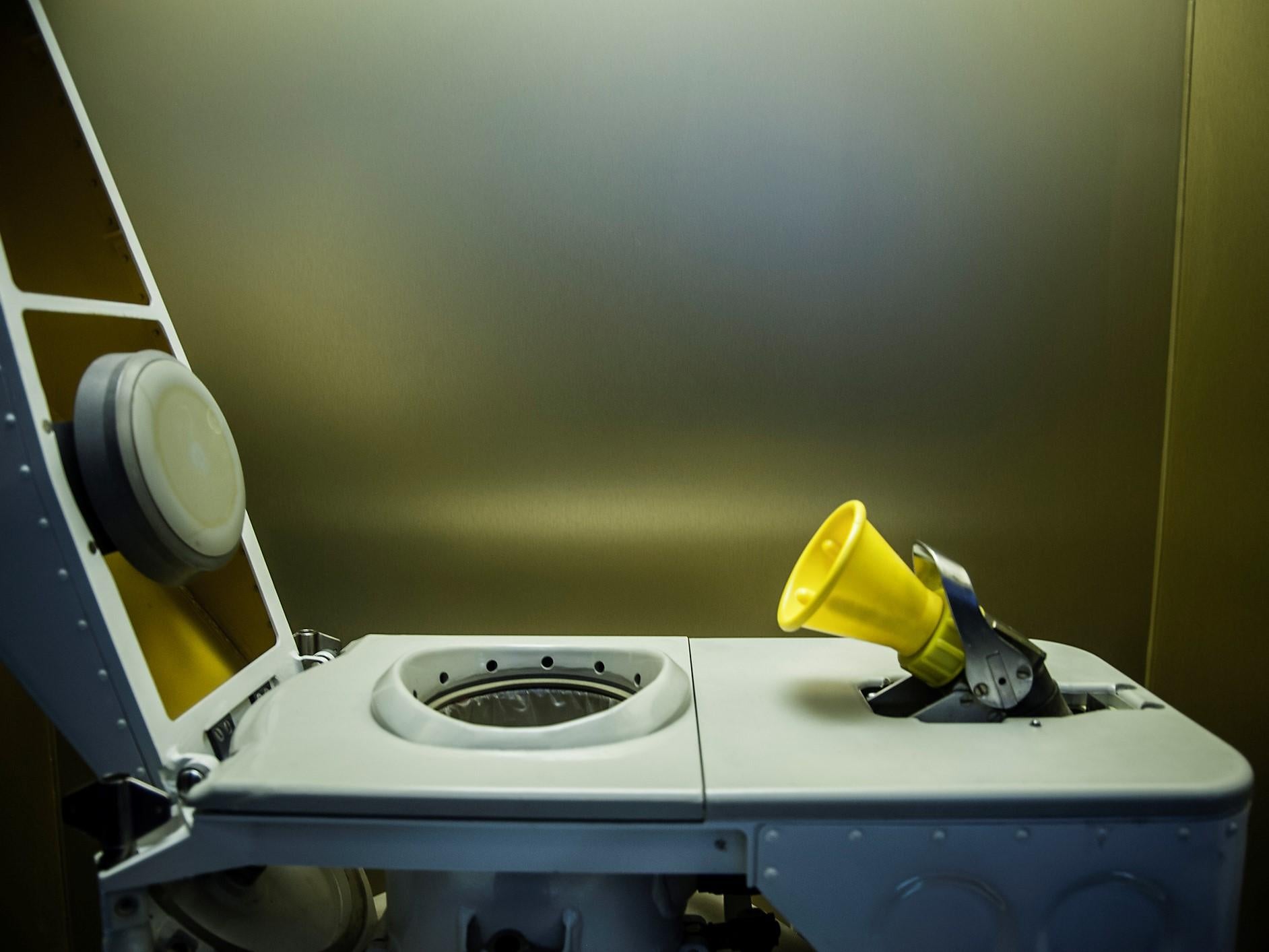 A side profile view of a toilet designed for use in space. The ISS toilet was installed more than a decade ago