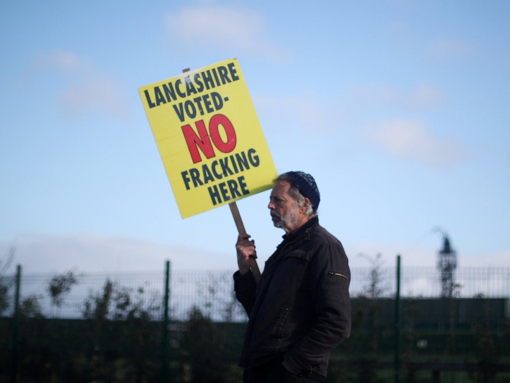 A protester stands outside Cuadrilla’s Preston Road fracking site near Blackpool