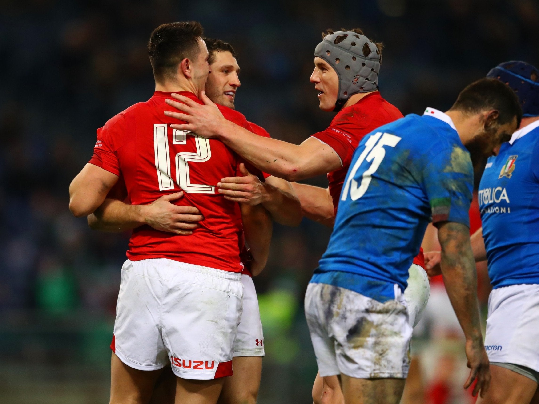 Owen Watkin is congratulated by his Wales teammates after scoring their second try against Italy