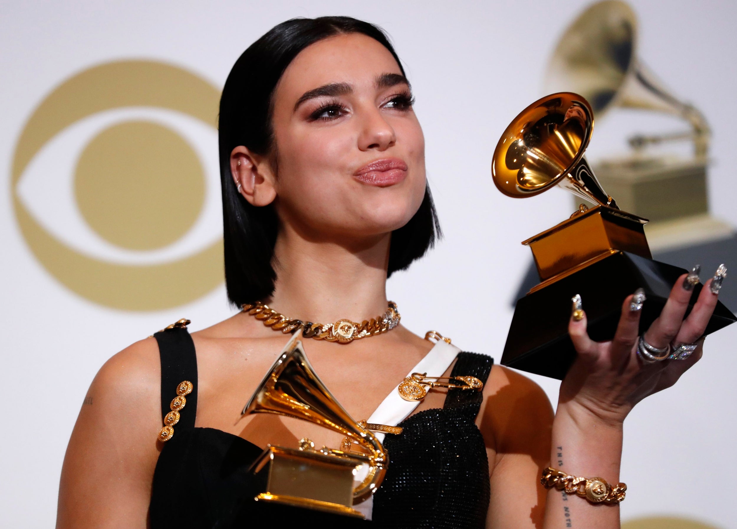 Dua Lipa poses backstage with her Grammys