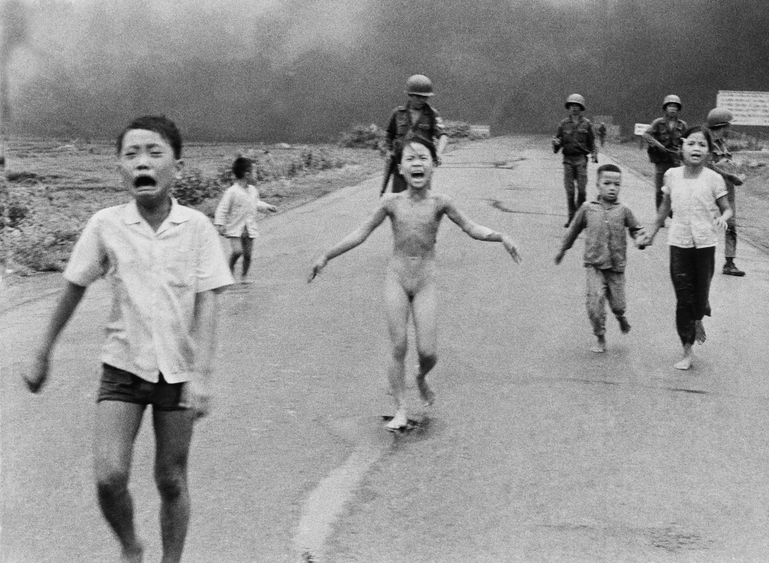 In this June 8, 1972 file photo, South Vietnamese forces follow after terrified children, including 9-year-old Kim Phuc, center, as they run down Route 1 near Trang Bang after an aerial napalm attack on suspected Viet Cong hiding places