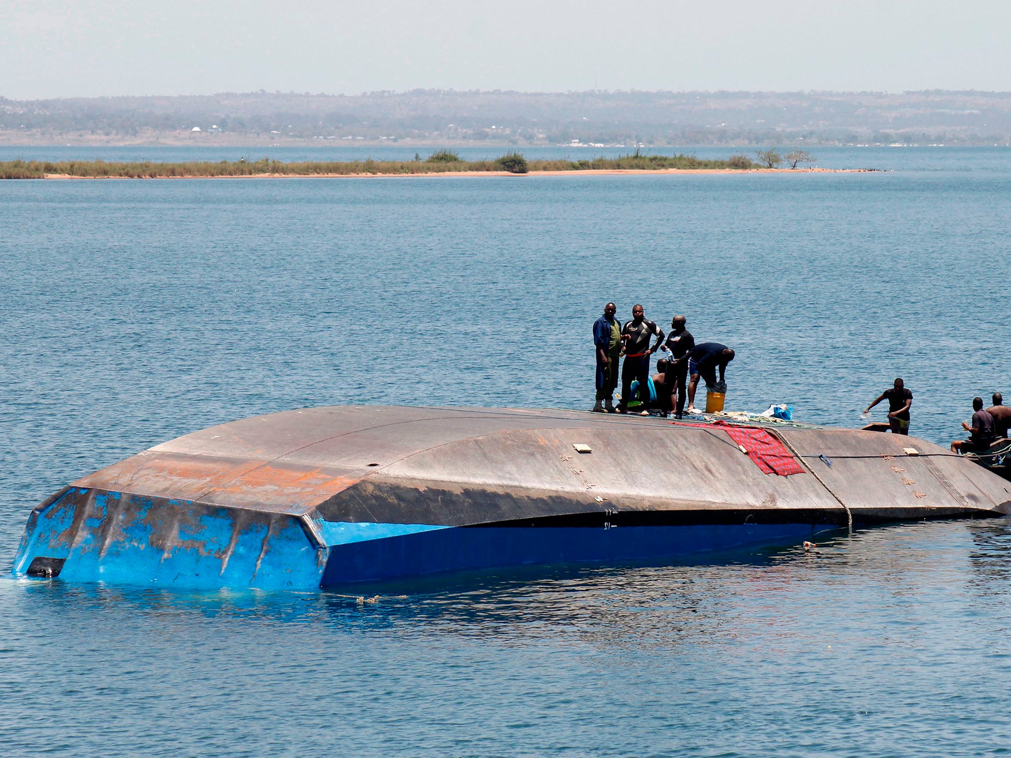 Tanzanian rescue workers search for victims a day after the ferry MV Nyerere capsized in Lake Victoria