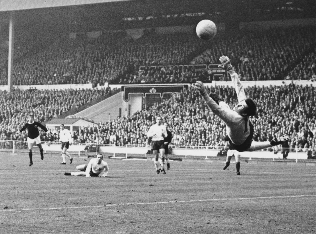 Gordon Banks saves a shot from Denis Law during an England vs Scotland match in 1967