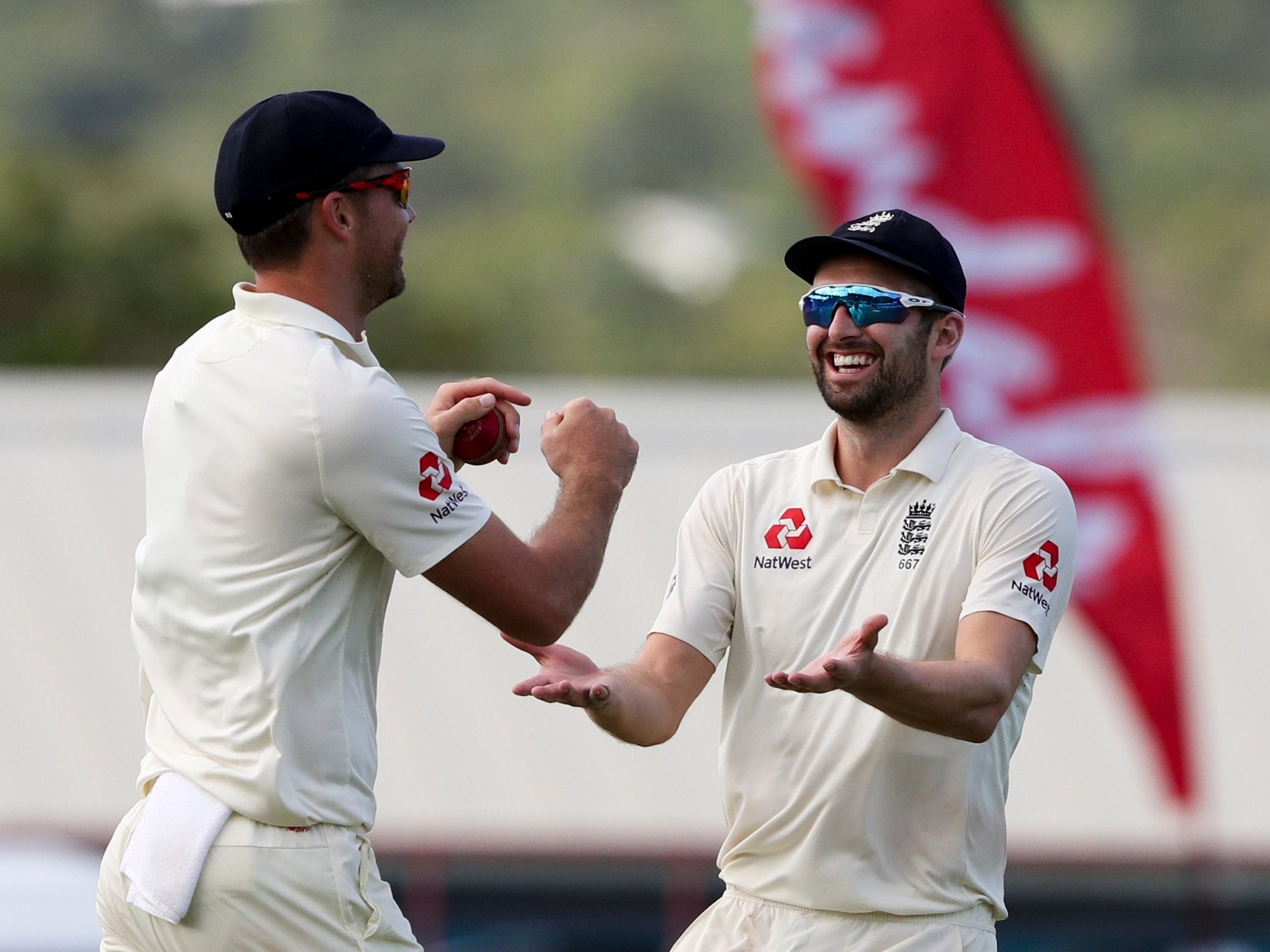 James Anderson and Mark Wood celebrate the wicket of Alzarri Joseph