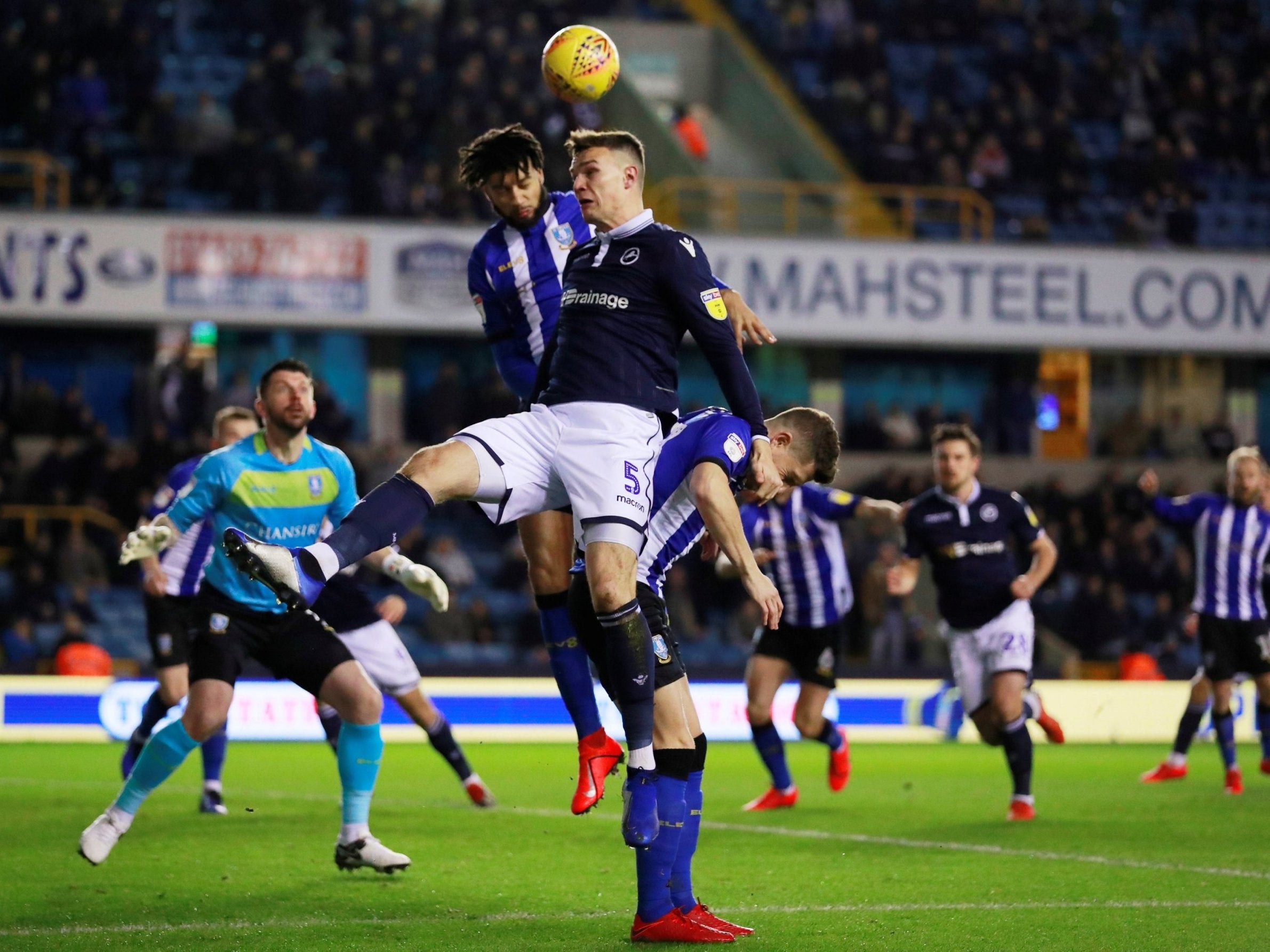 Millwall’s Jake Cooper in action with Sheffield Wednesday’s Michael Hector