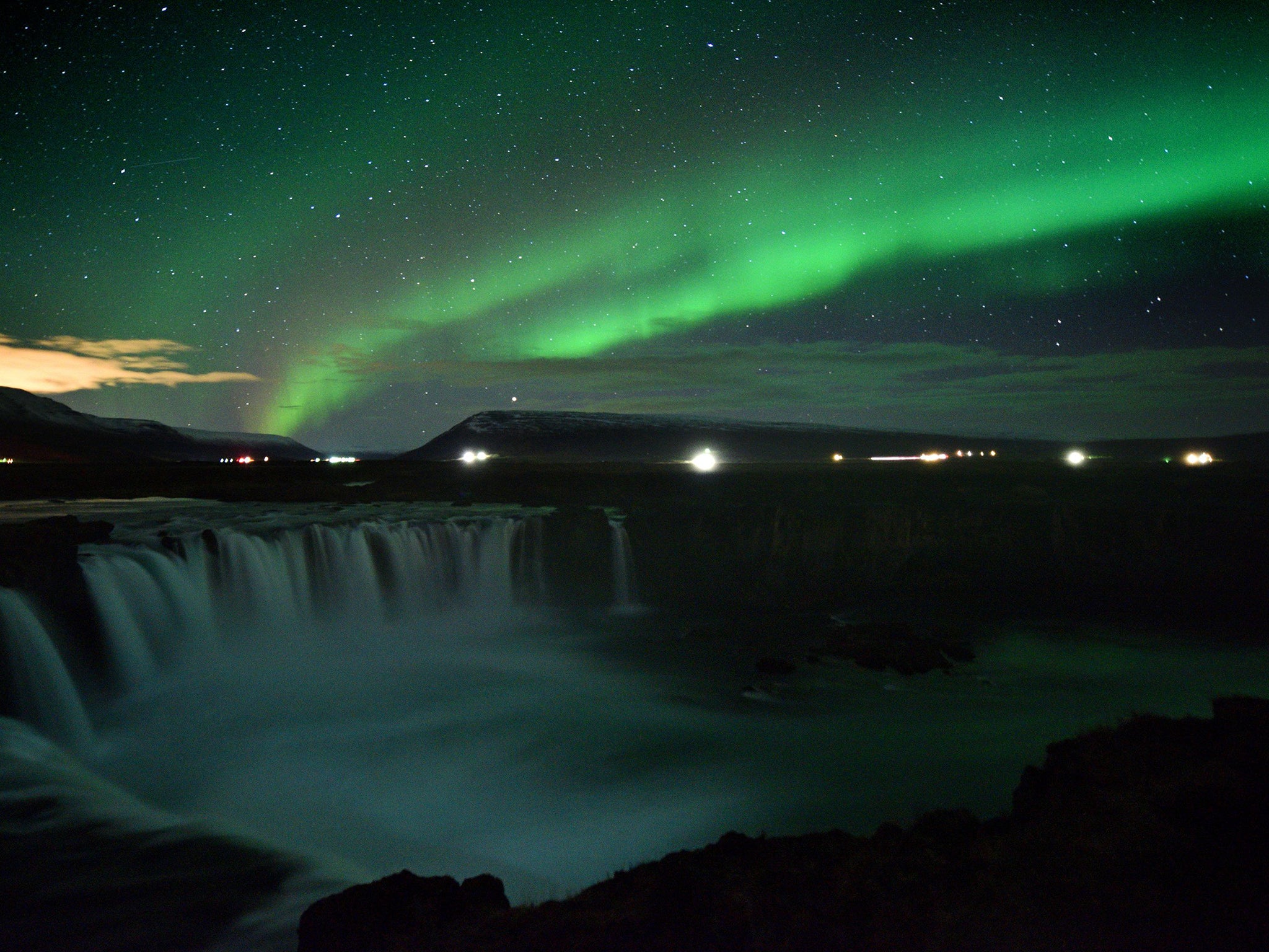 The Northern Lights over Godafoss waterfall in Iceland