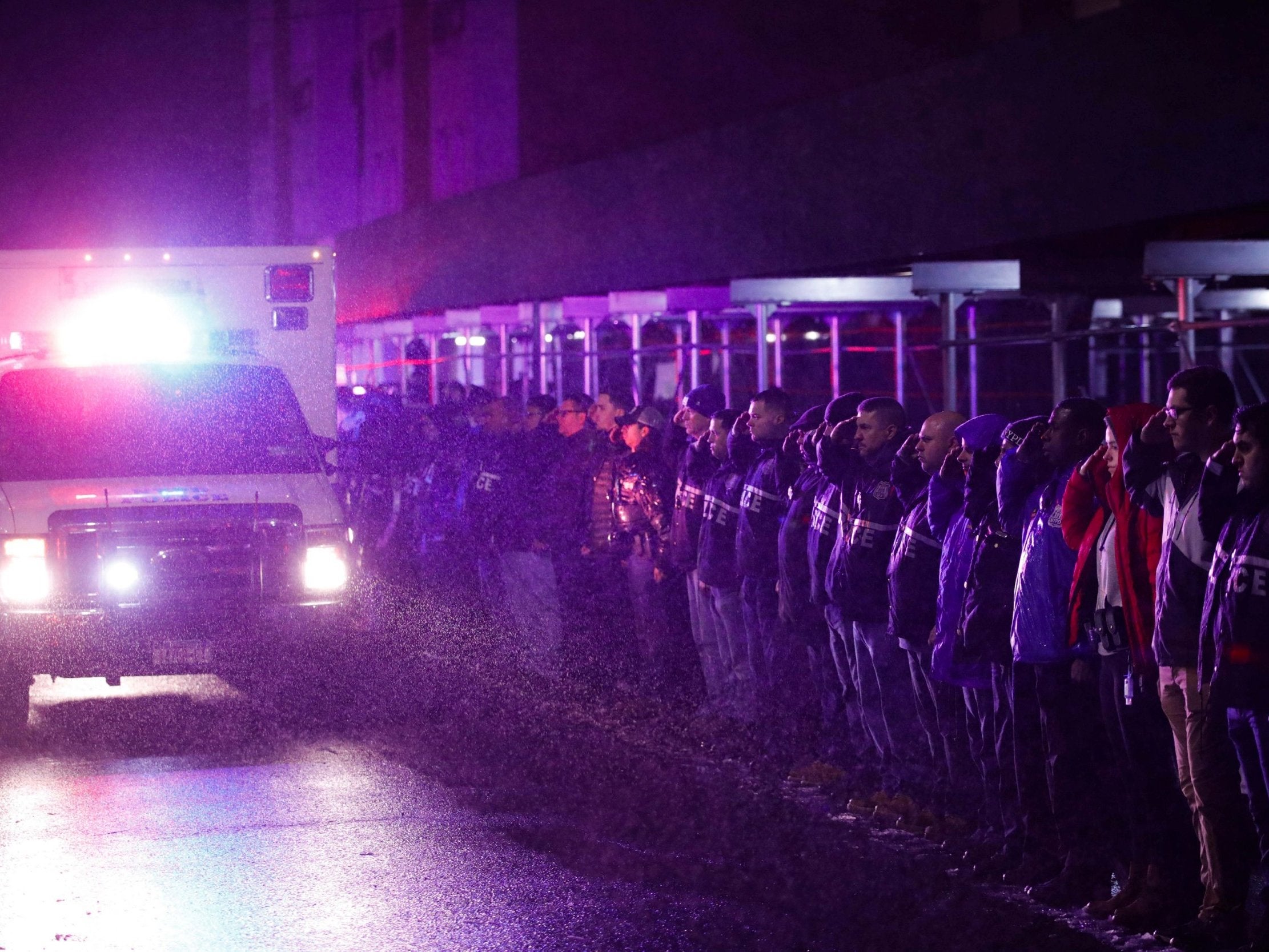 Officers salute a procession as the remains of slain Detective Brian Simonsen pass by