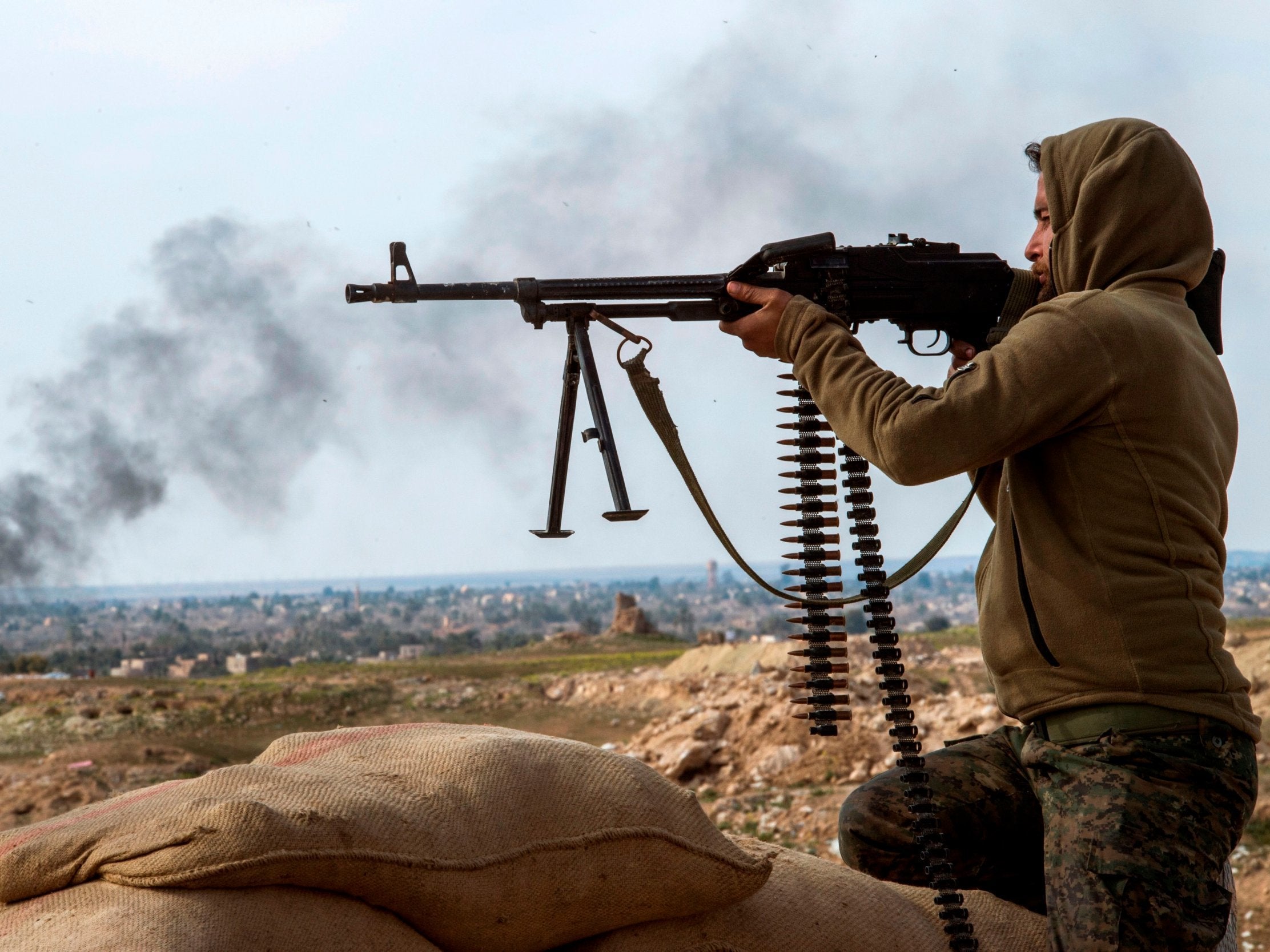 An SDF fighter holds his position during an anti-Isis operation (AFP/Getty)