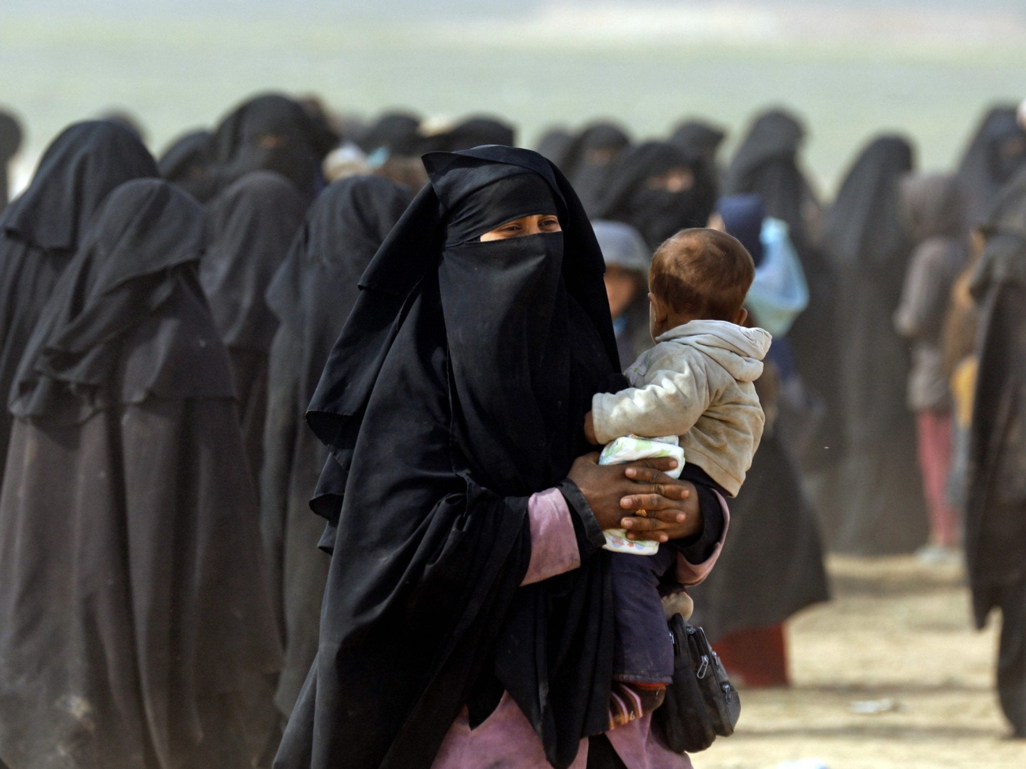 Woman holding her baby among the civilians fleeing Isis holdout of Baghouz in February