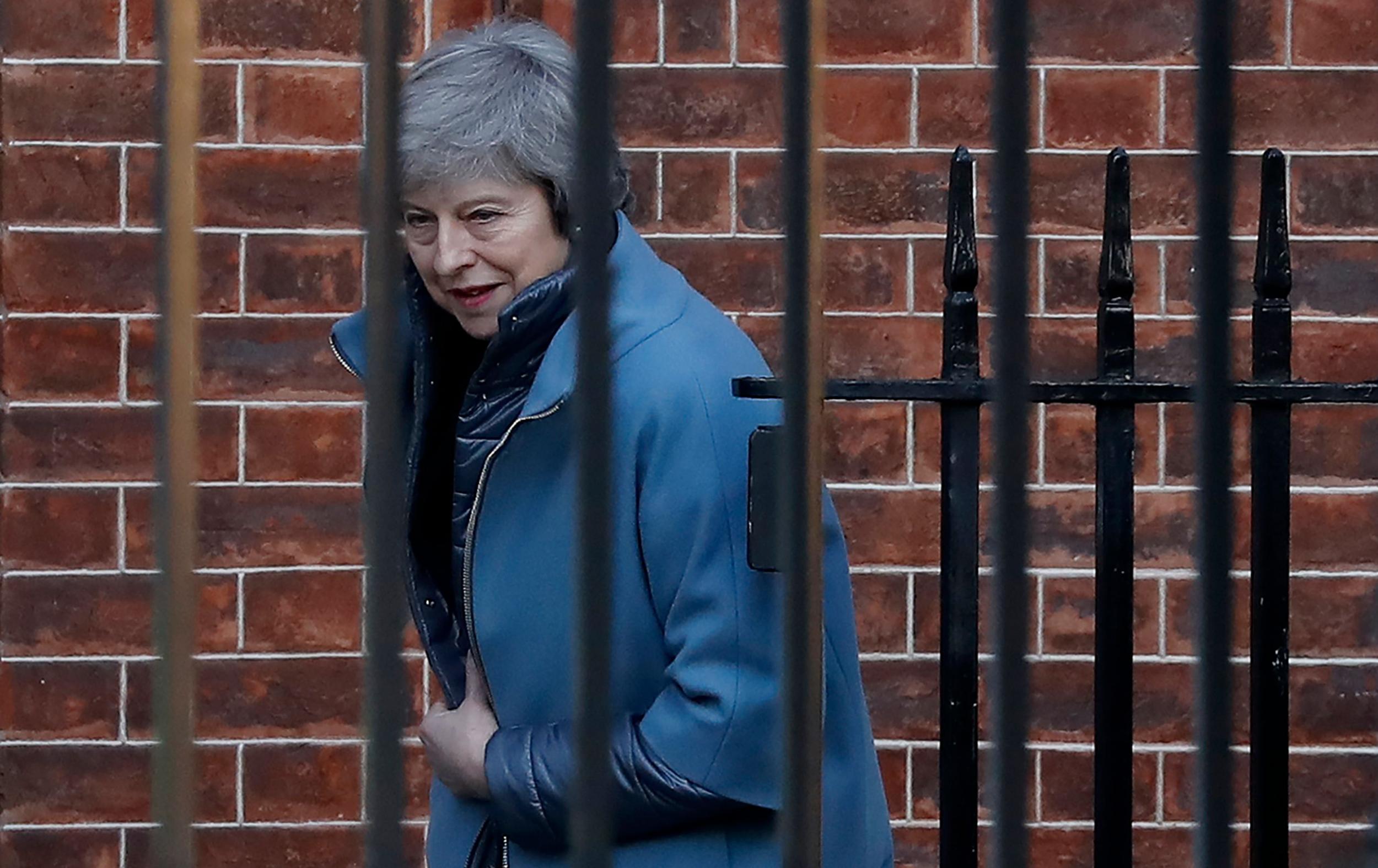 Theresa May leaves from the rear of 10 Downing Street