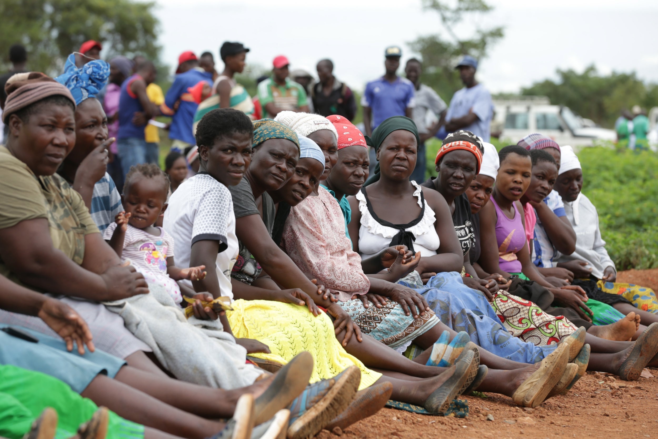 Locals and family members gather at Cricket Mine outside Kadoma more than 200 km west of the capital Harare, Zimbabwe, 14 February 2019 where more than 40 artisanal miners died on 12 February 2019. The miners died when the shafts in which they working in were flooded by raining water. Efforts are being made to pump out the water so that the bodies can be retrieved.