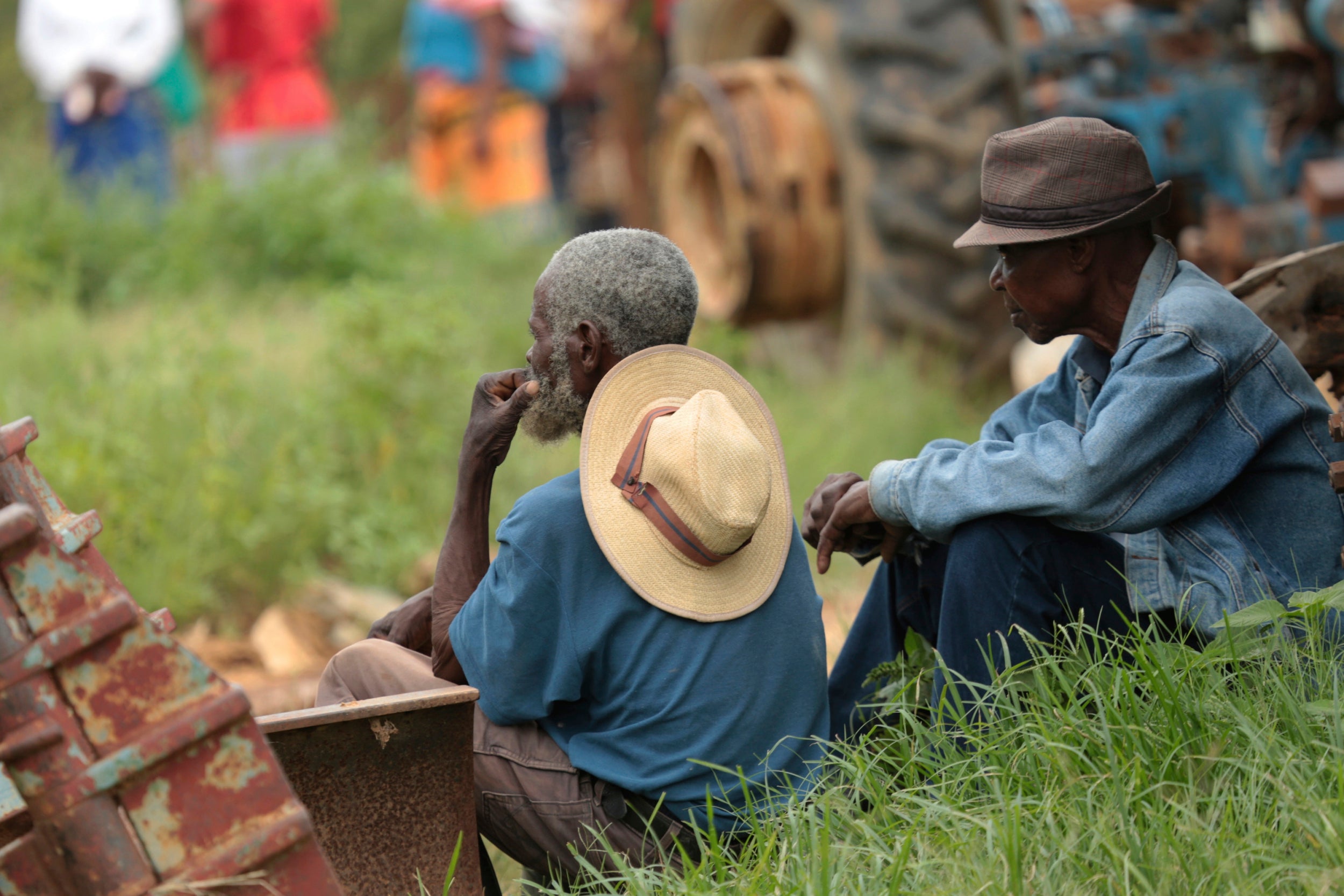 Relatives of trapped miners look on, near a mineshaft where some tens of artisanal gold miners are feared dead after rains flooded the mines while they were underground on the outskirts of Kadoma town about 200 kilometres west of Harare, Zimbabwe, Thursday, Feb, 14, 2019.  Hopes of rescuing the trapped miners are fading due to lack of necessary equipment after they were reported missing Wednesday.