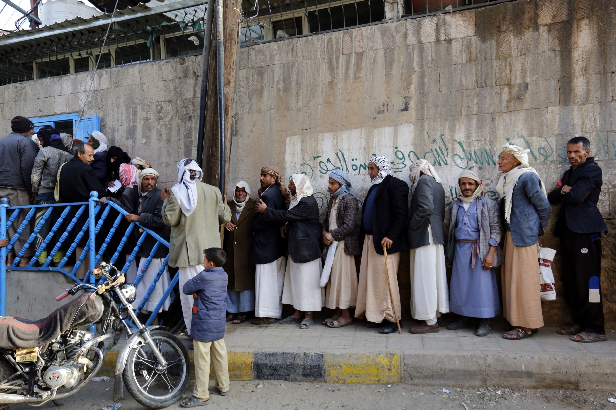 Yemenis line up for free bread amid a severe shortage of food in Sana’a