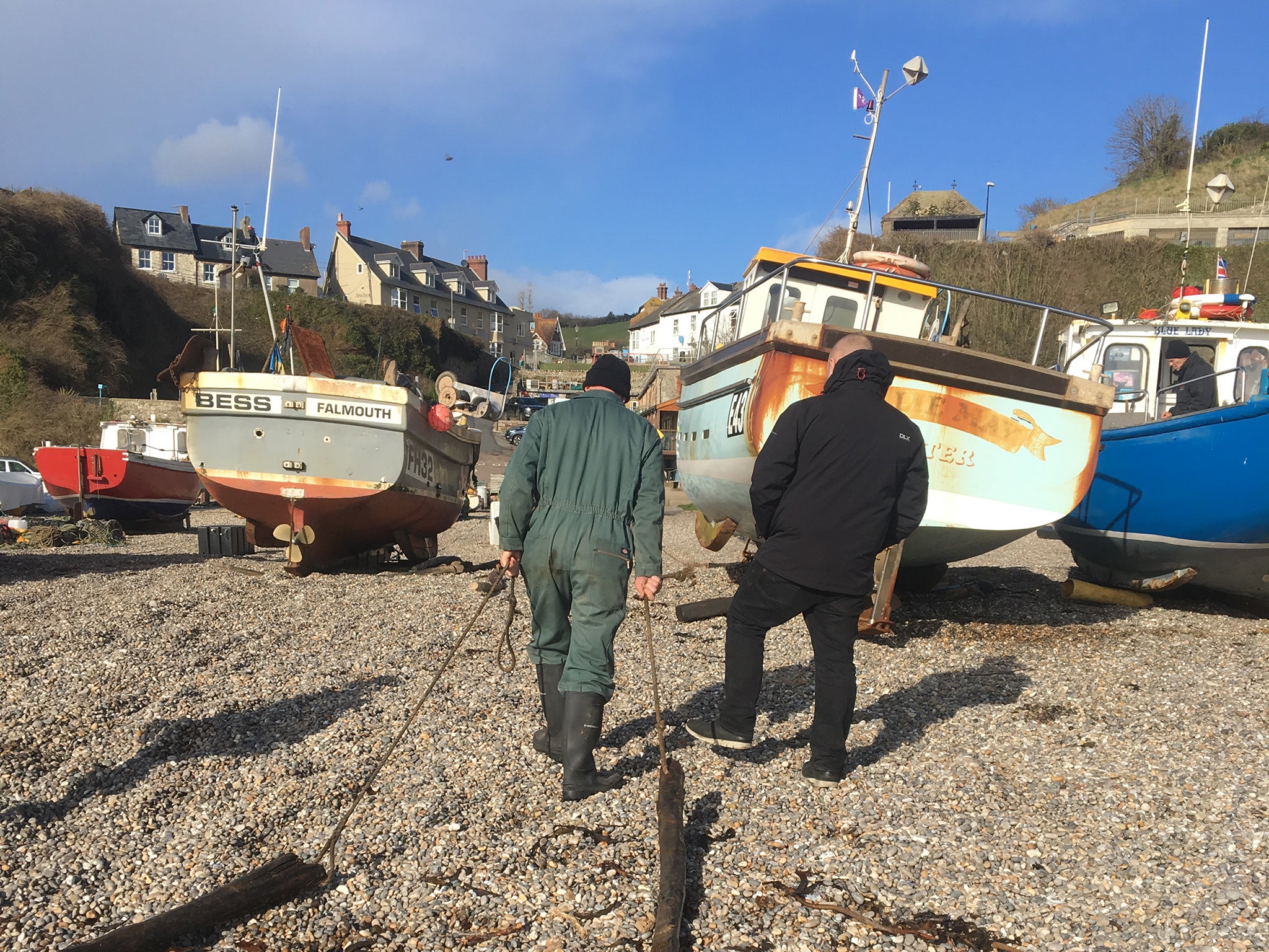 Jim and Paul dragging planks up the beach