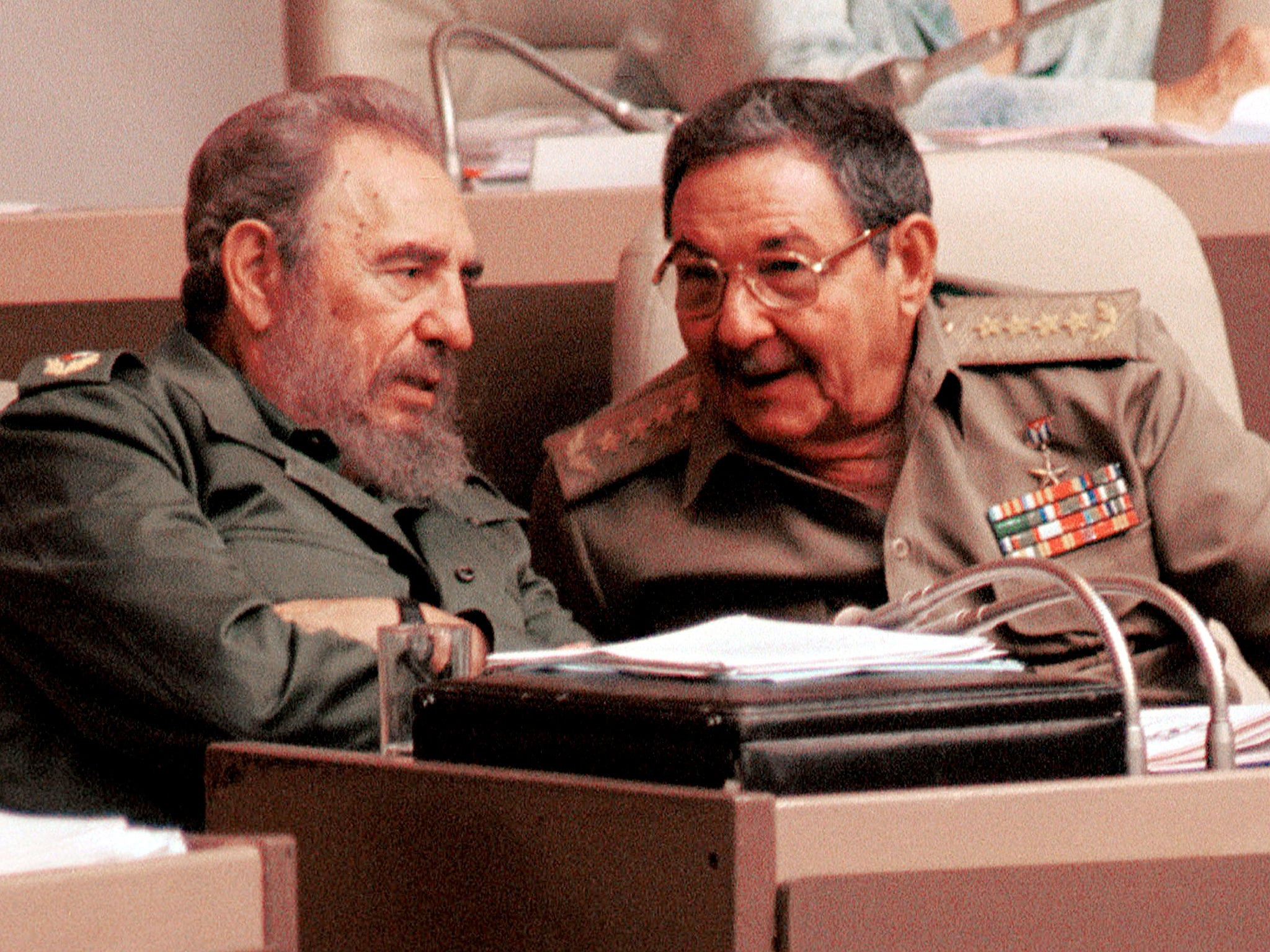 Fidel Castro and his brother Raul speak during a session of the National Assembly legislature in Havana, Cuba in 2001