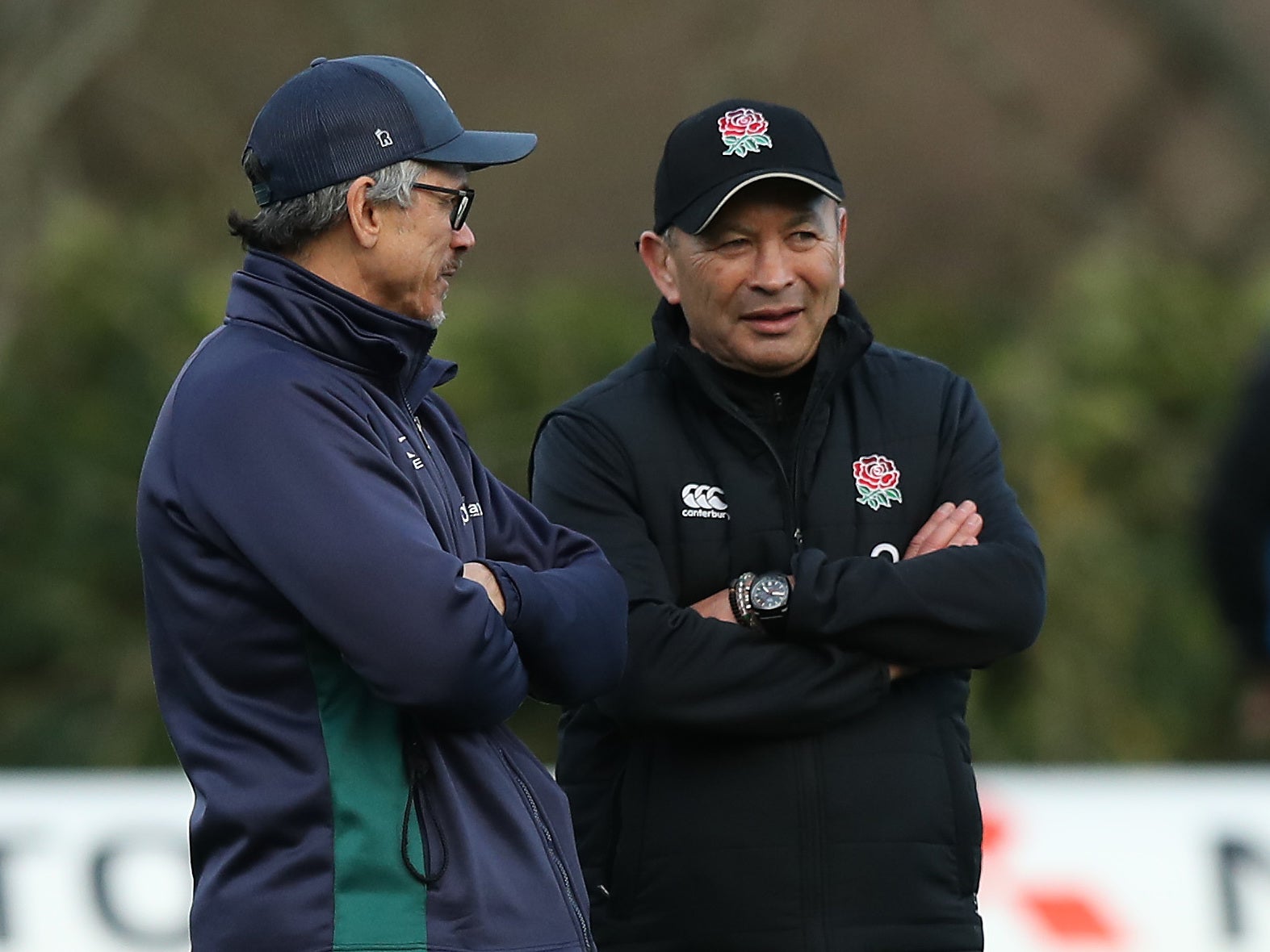 London Irish head coach Les Kiss speaks with England's Eddie Jones as the two sides train together