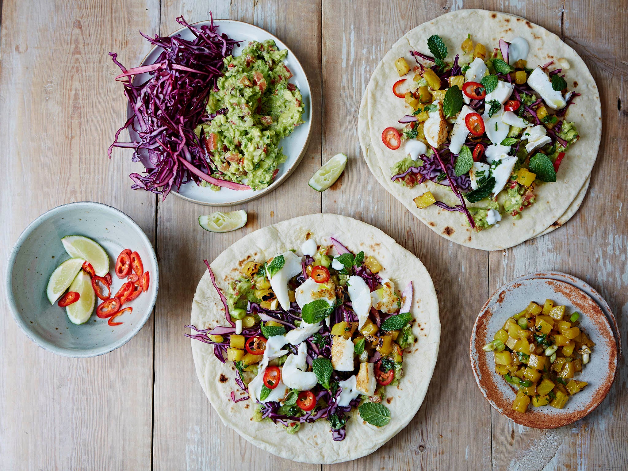 The real making of fish tacos is all the trimmings: cabbage, sour cream, fresh guacamole and a spicy salsa