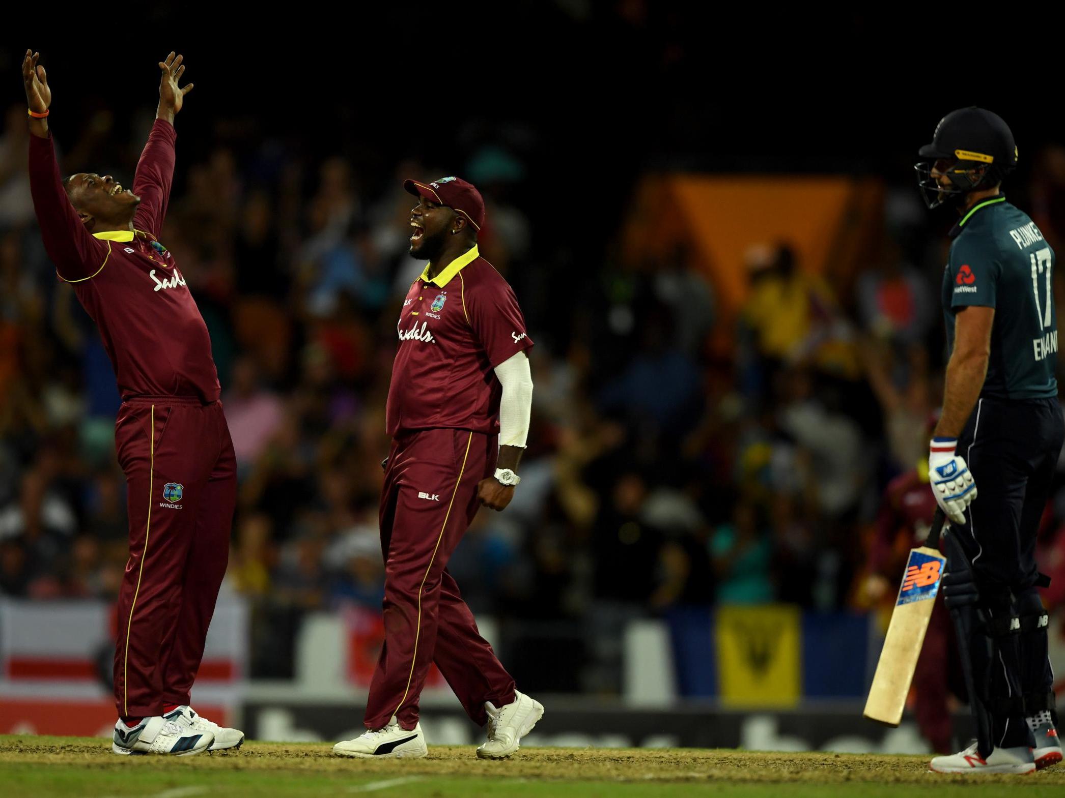 Sheldon Cottrell celebrates with Ashley Nurse after Moeen Ali's dismissal