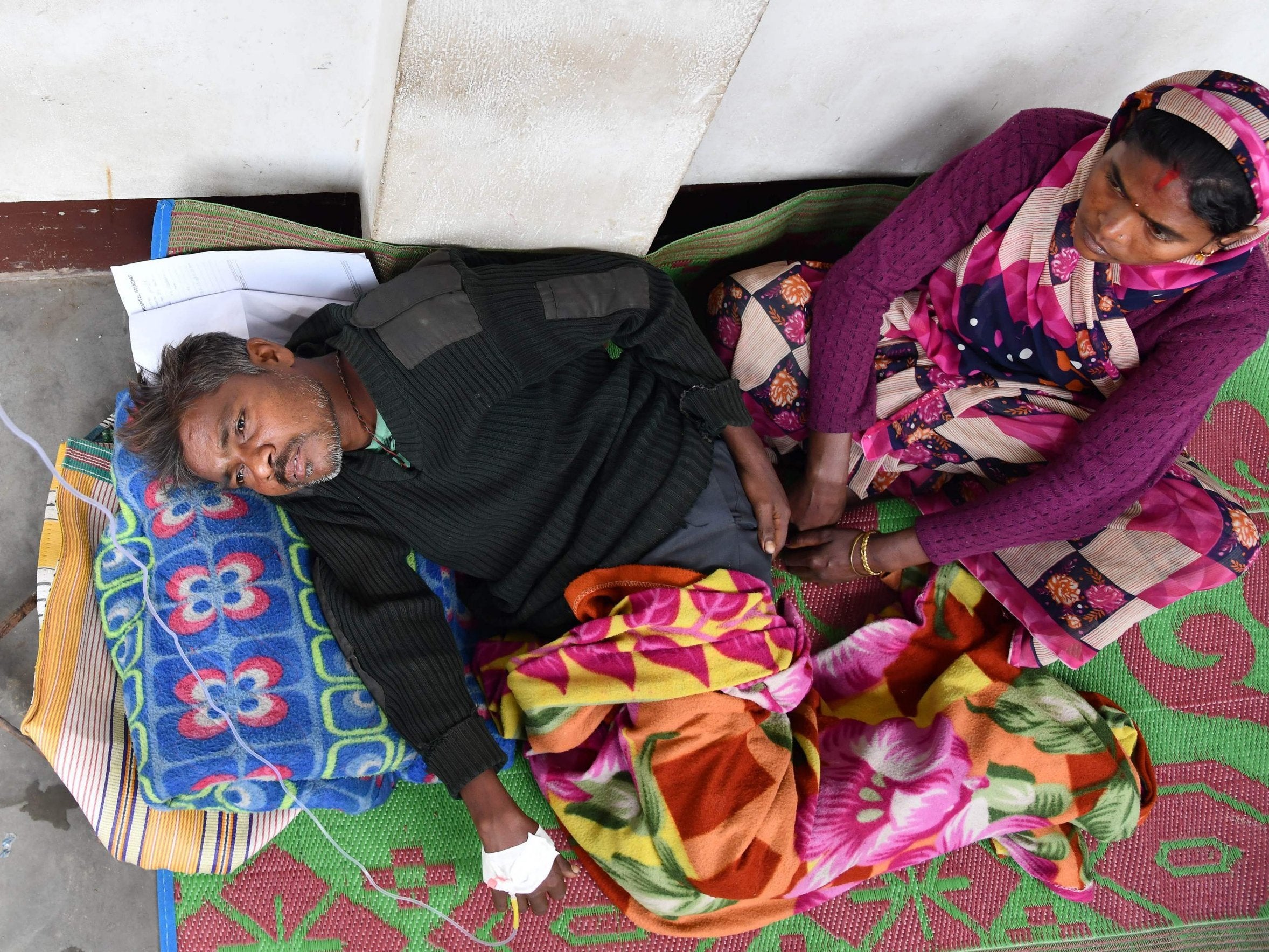 An Indian patient who drank toxic bootleg liquor is treated at Kushal Konwar Civil Hospital in Golaghat district in the northeastern Indian state of Assam