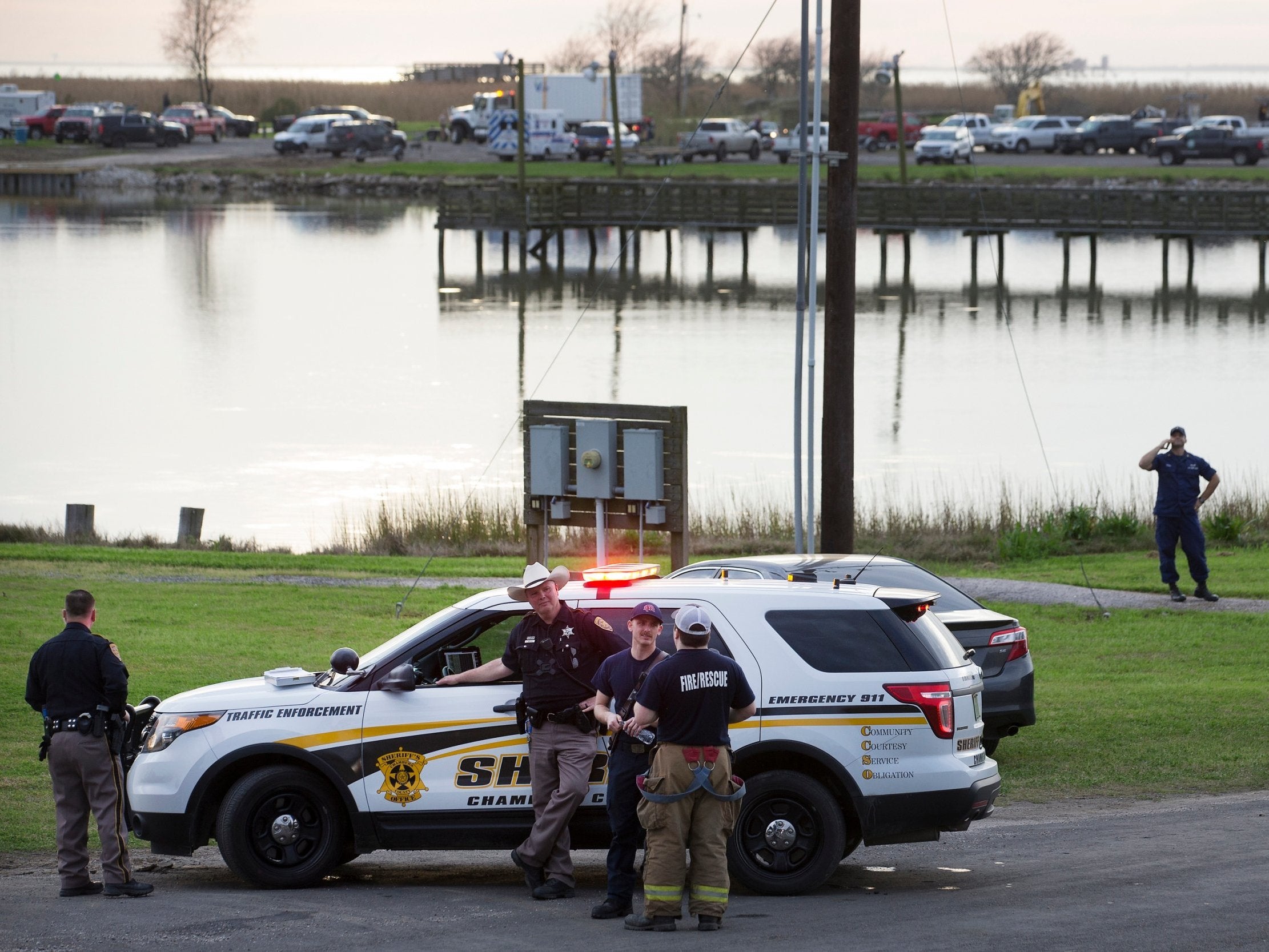 Police officers man a road block during the investigation of a plane crash in Trinity Bay