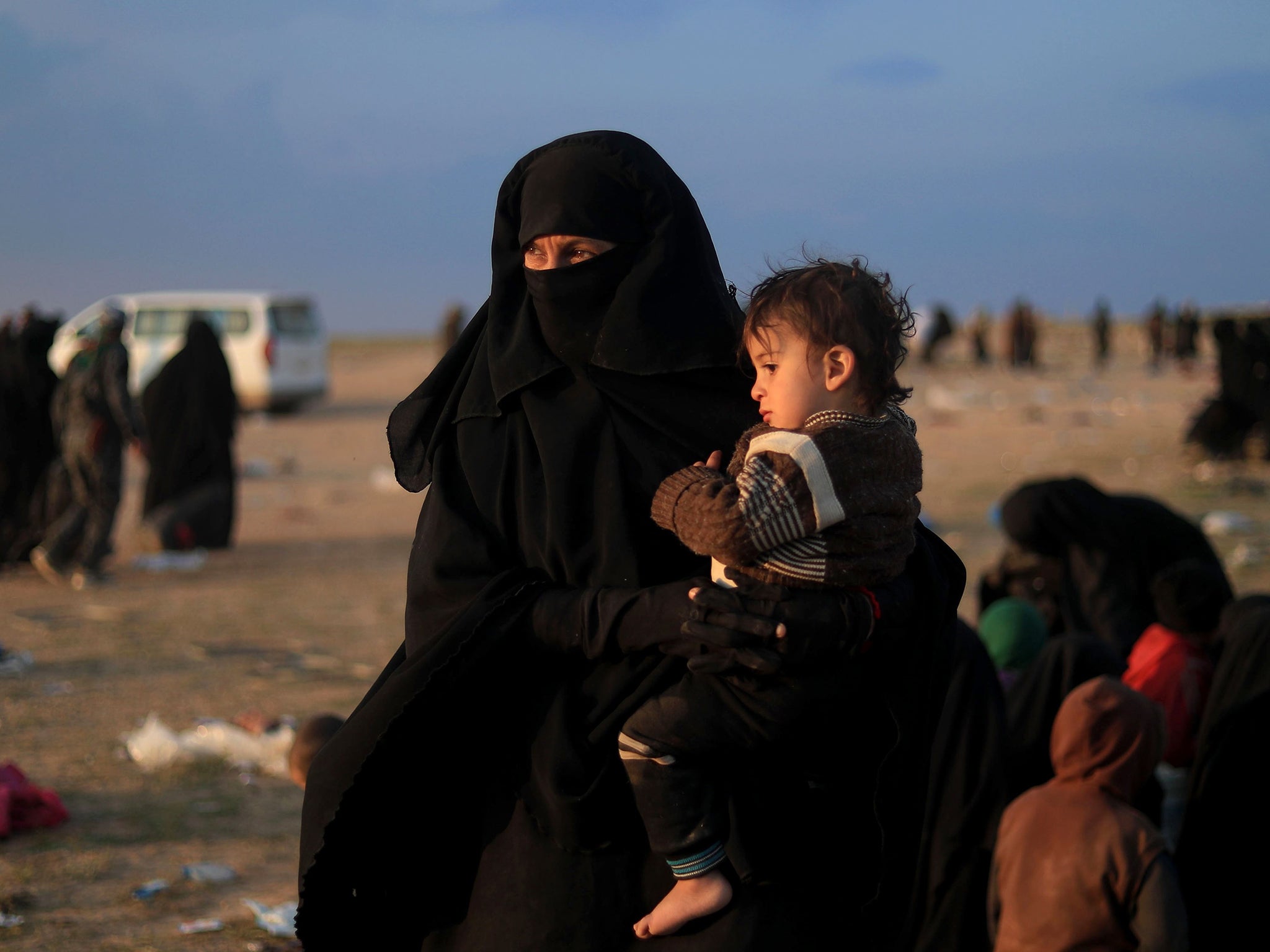 Women and children flee Isis’s last holdout of Baghouz which is surrounded by US-backed forces (Getty)