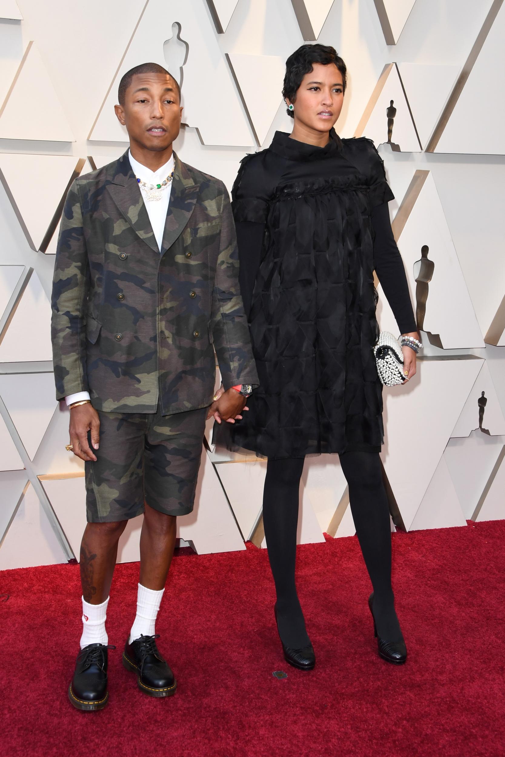 Pharrell Williams and wife, model Helen Lasichanh, pose on the Oscars red carpet