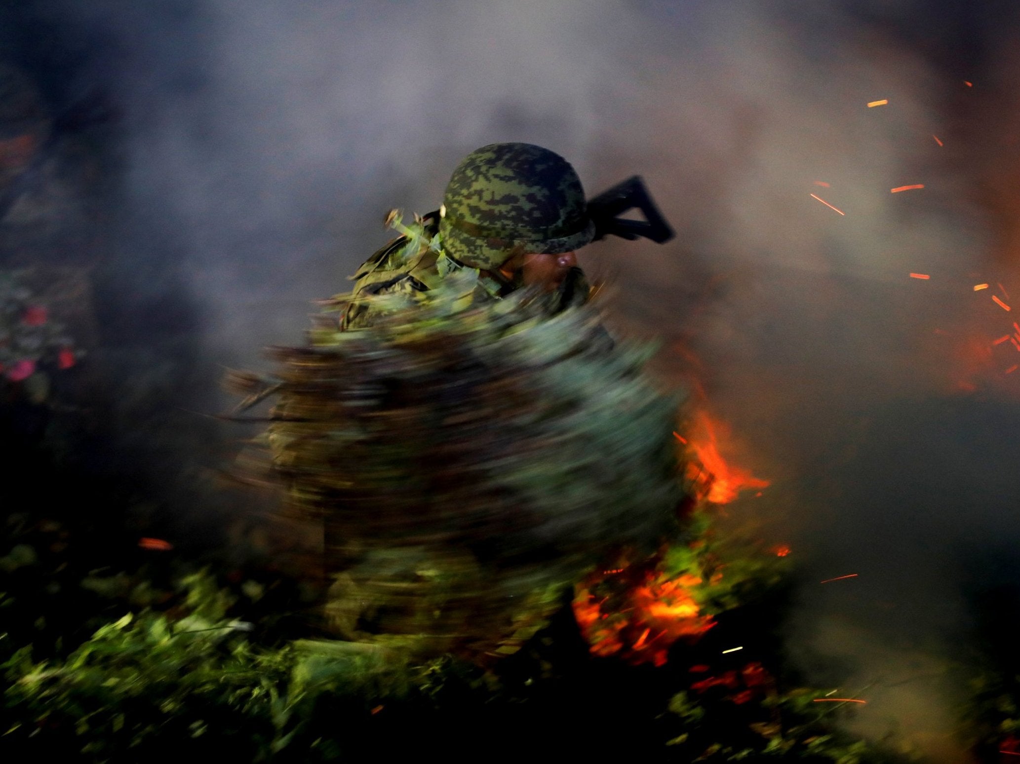 A soldier burns an illegal opium plantation in the southern state of Guerrero