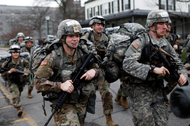 US Military cadets run in full combat gear as they start competing in the 50th annual Sandhurst Military Skills Competition