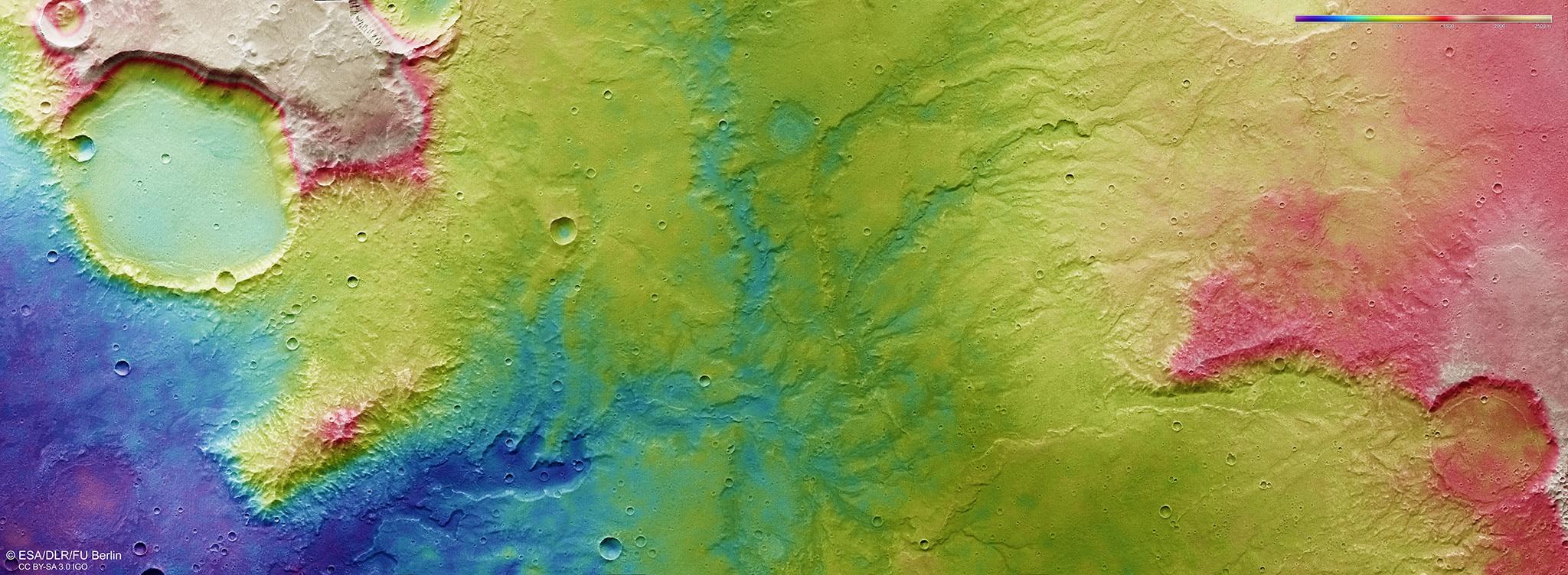 This colour-coded topographic view shows the relative heights of the terrain in and around the network of dried-up valleys on Mars.
Lower parts of the surface are shown in blues and purples, while higher altitudes show up in whites, yellows, and reds, as indicated on the scale to the top right.