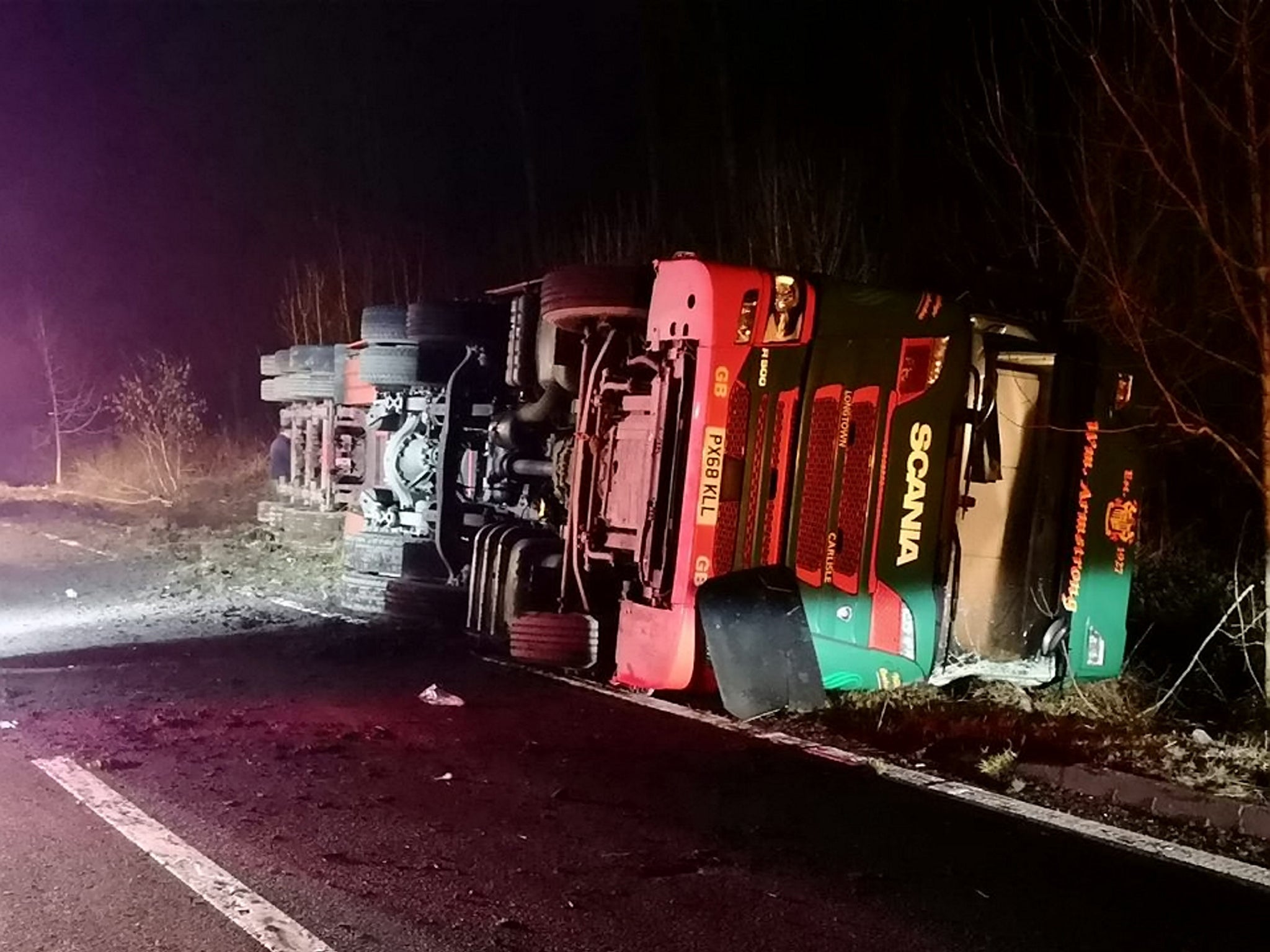 The lorry overturned on the A76 near Enterkinfoot, south of Sanquhar, Dumfries and Galloway