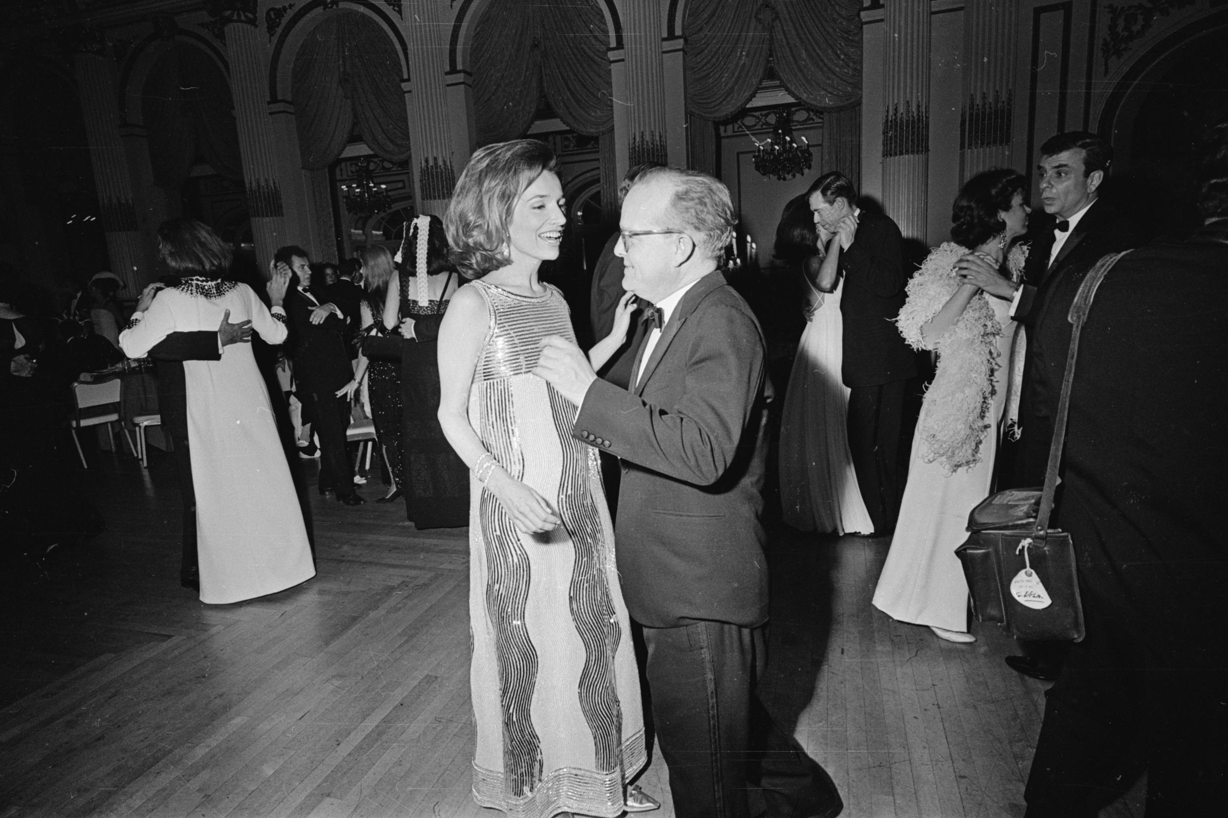 Radziwill dances with novelist Truman Capote at his Black and White Ball at the Plaza Hotel, New York, 1966