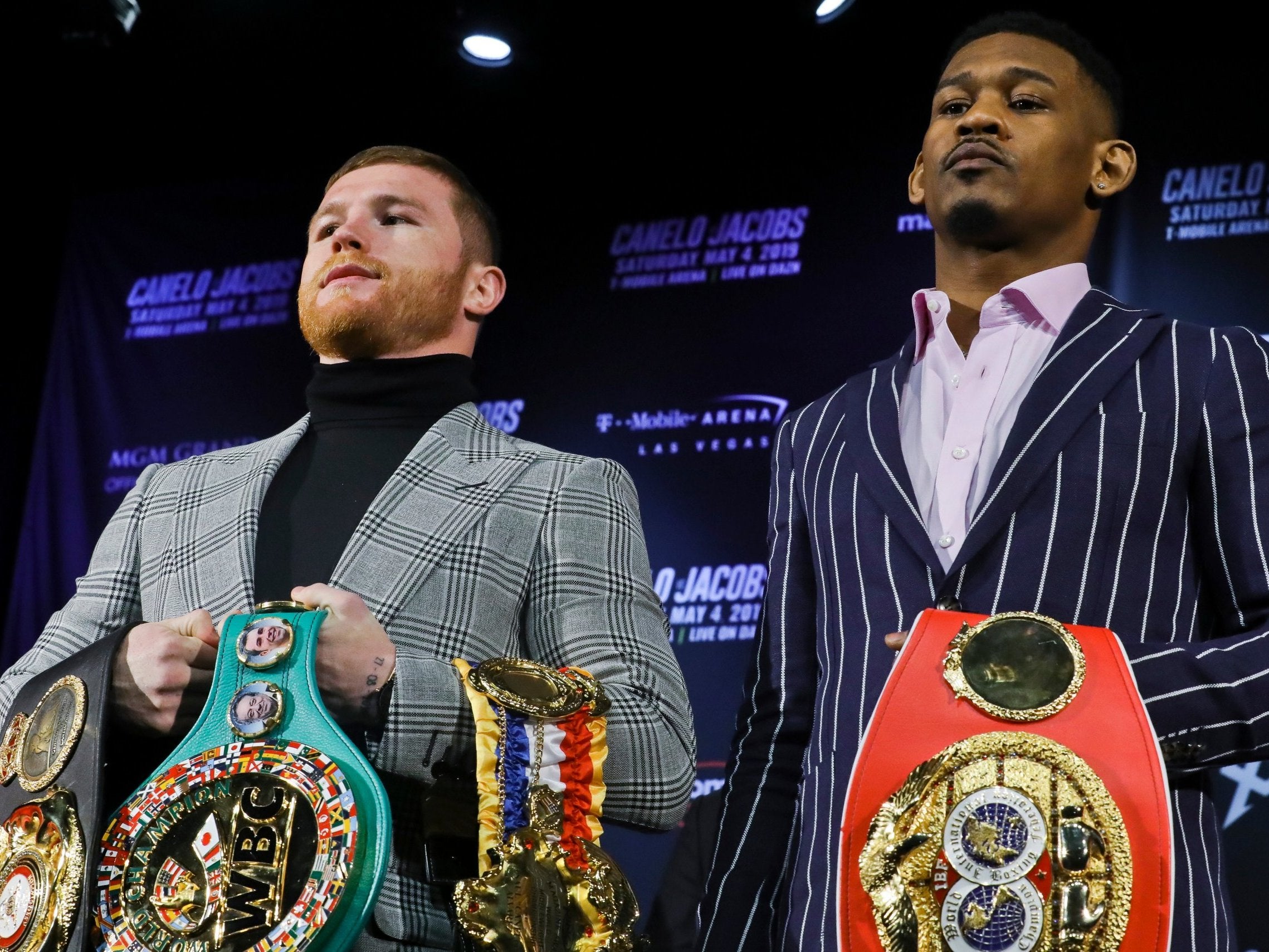 Canelo Alvarez and Danny Jacobs pose with their belts