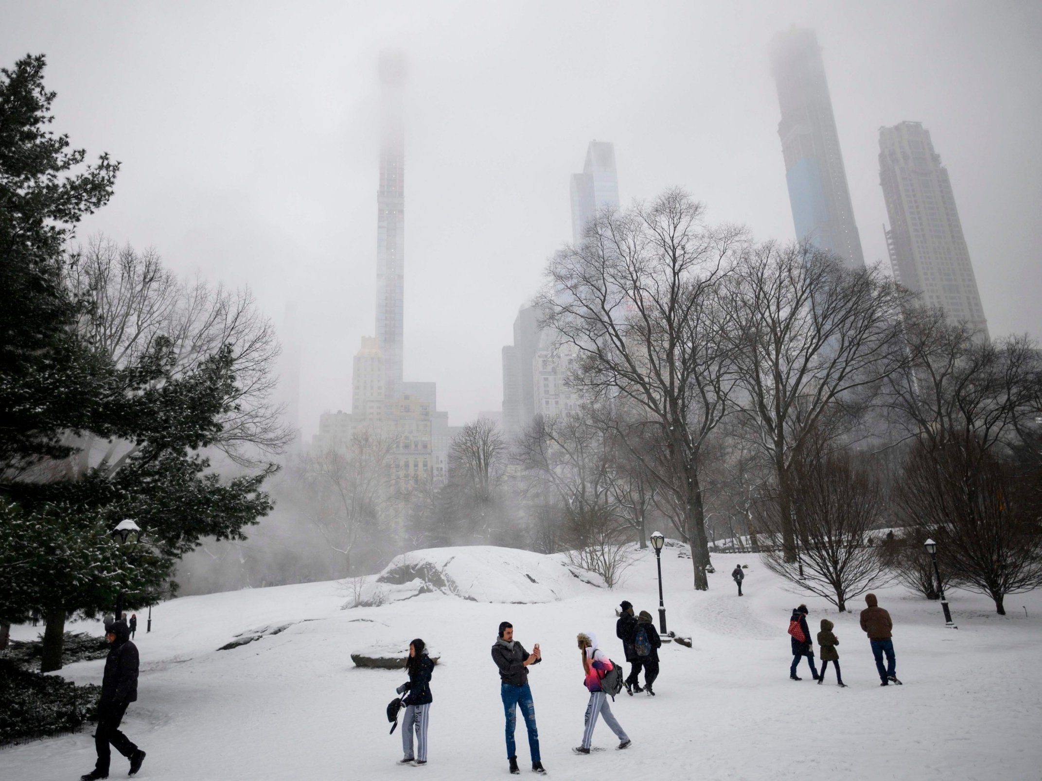 People walk in Central Park during snowfall on 10 February 2019 in New York City. A winter storm is hitting the eastern part of the United States.