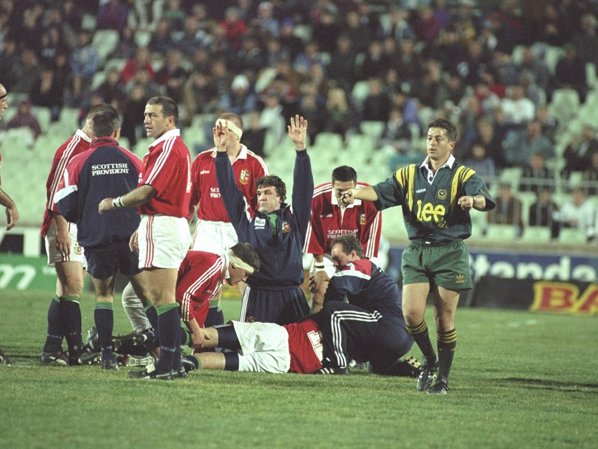 A call for the stretcher goes out as Will Greenwood of the British &amp; Irish Lions lies suffering from concussion, during the 1997 tour match against Free State in South Africa