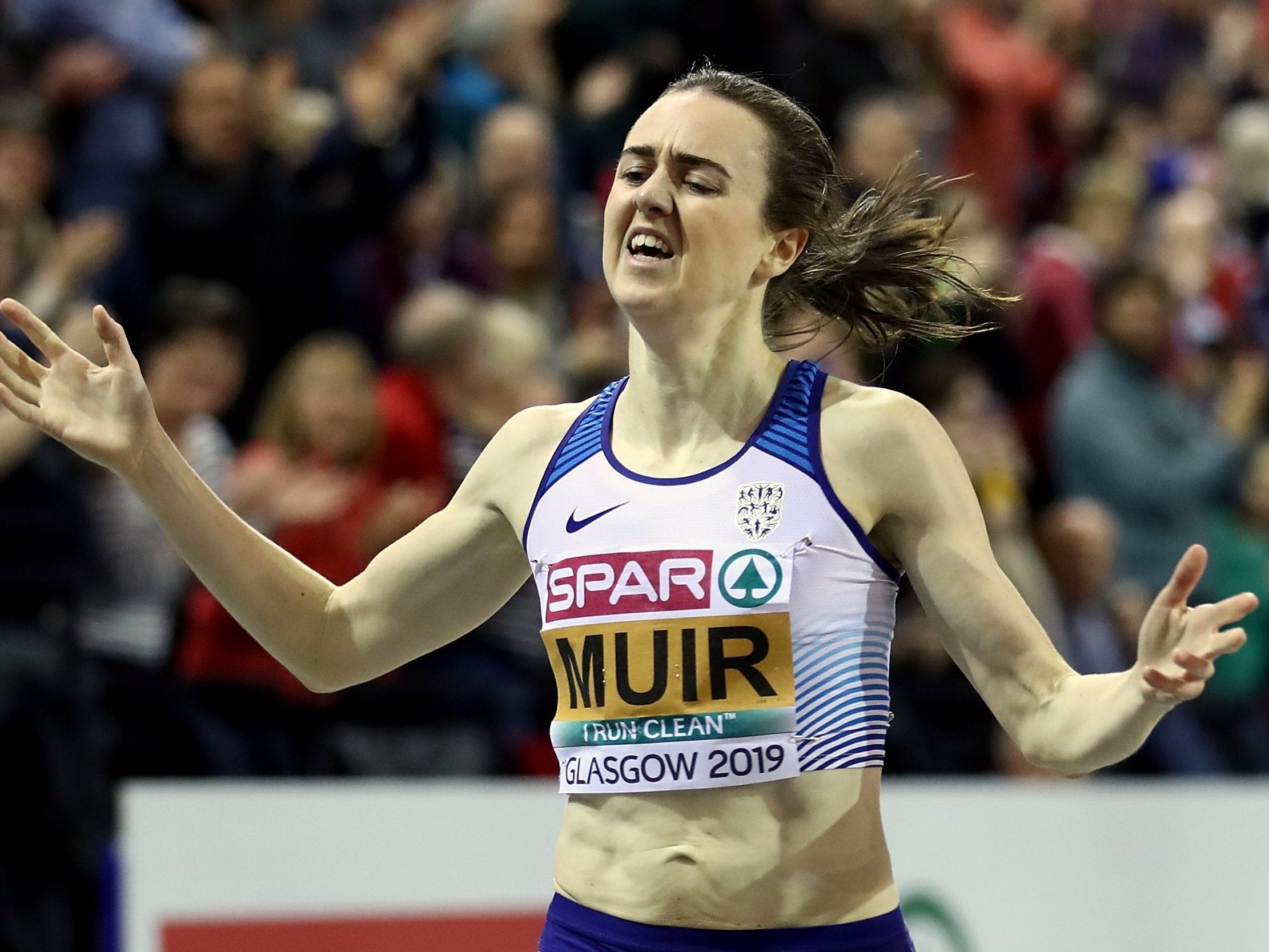 Laura Muir celebrates as she crosses the finish line to win the women's 3,000m final