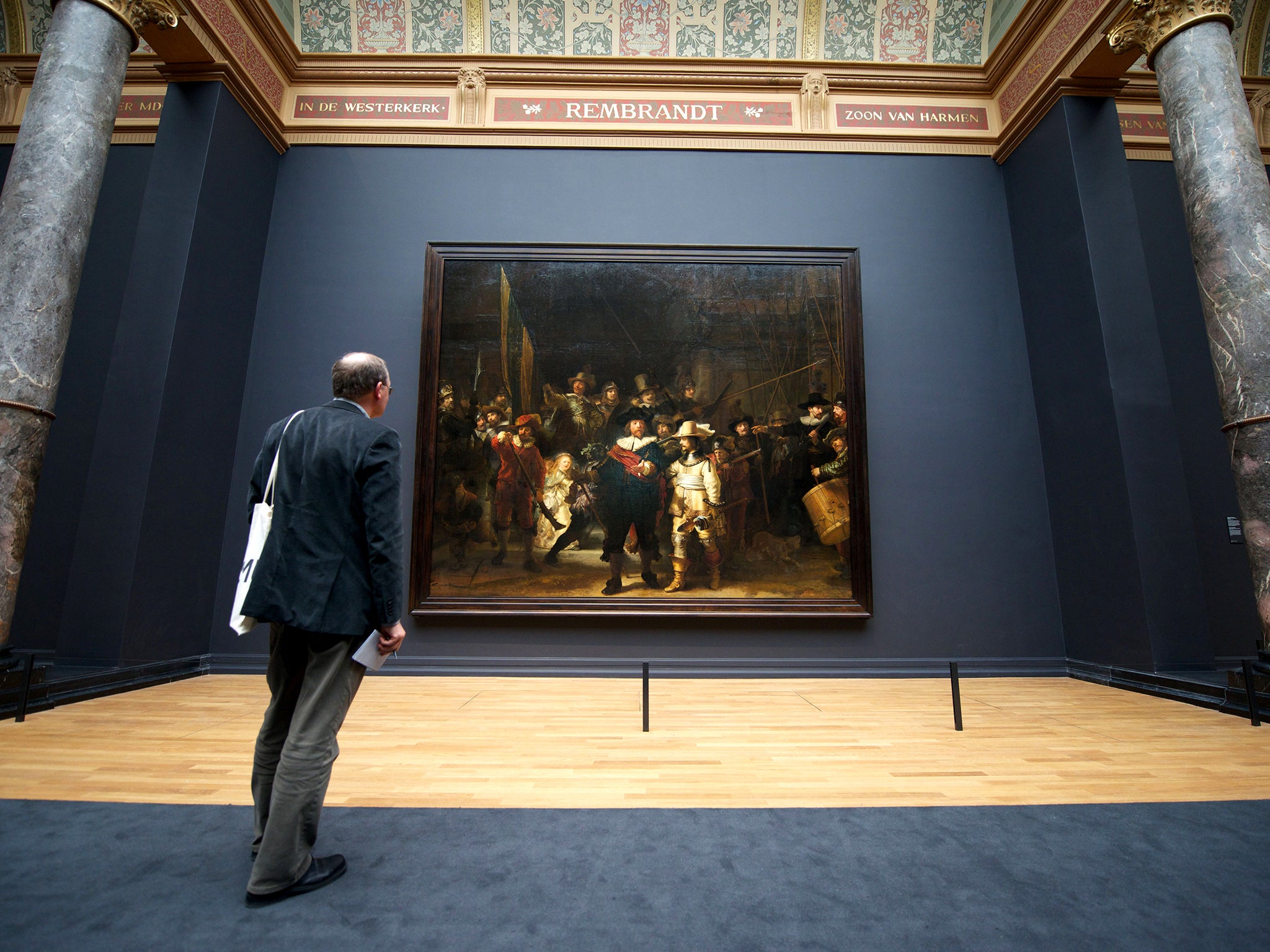 A visitor admires Rembrandt’s masterpiece ‘The Night Watch’ in Amsterdam’s Rijkmuseum (AFP/Getty)