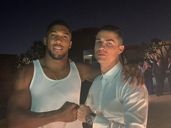 Joshua poses with Ronaldo