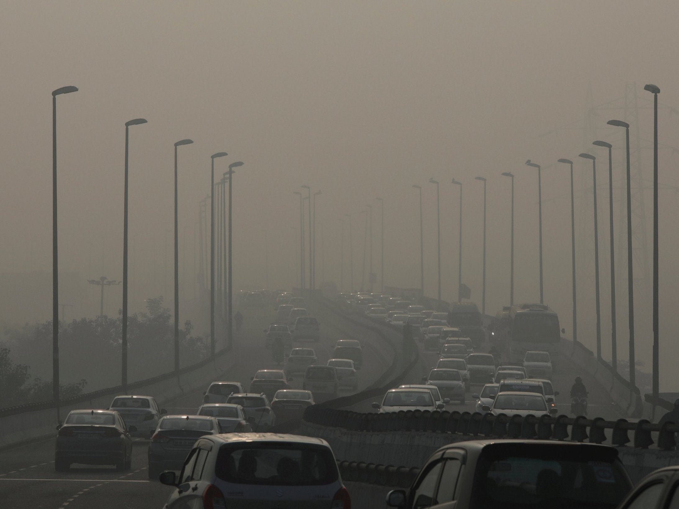 Vehicles drive through the smog in New Delhi