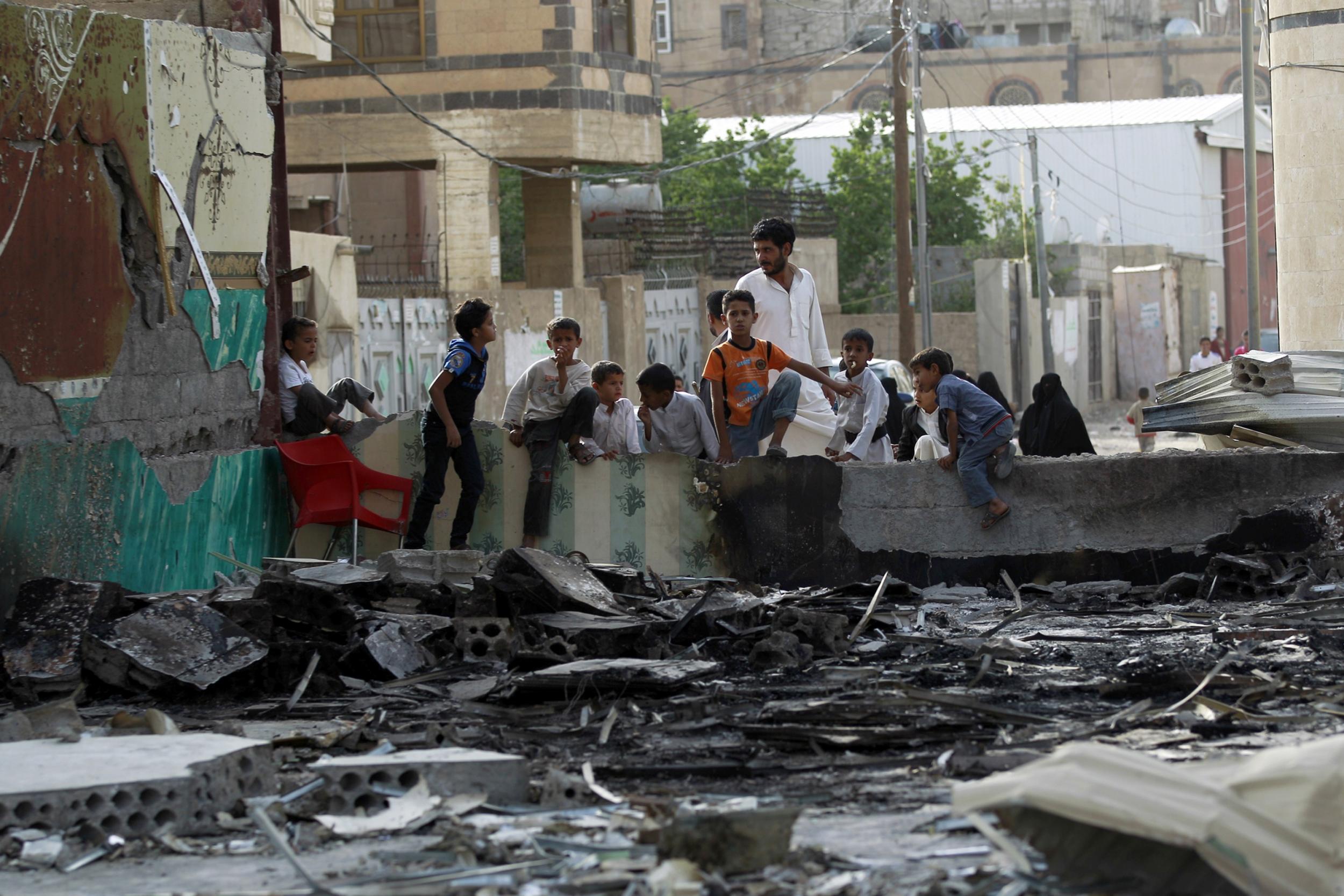 Yemeni children look at a wedding hall which was reportedly hit by a Saudi-led coalition air strike in the capital Sanaa, on July 10, 2015