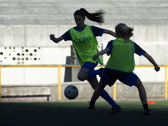 Two girls of Anorga KKE football school attend a training session in the Spanish Basque city of San Sebastian