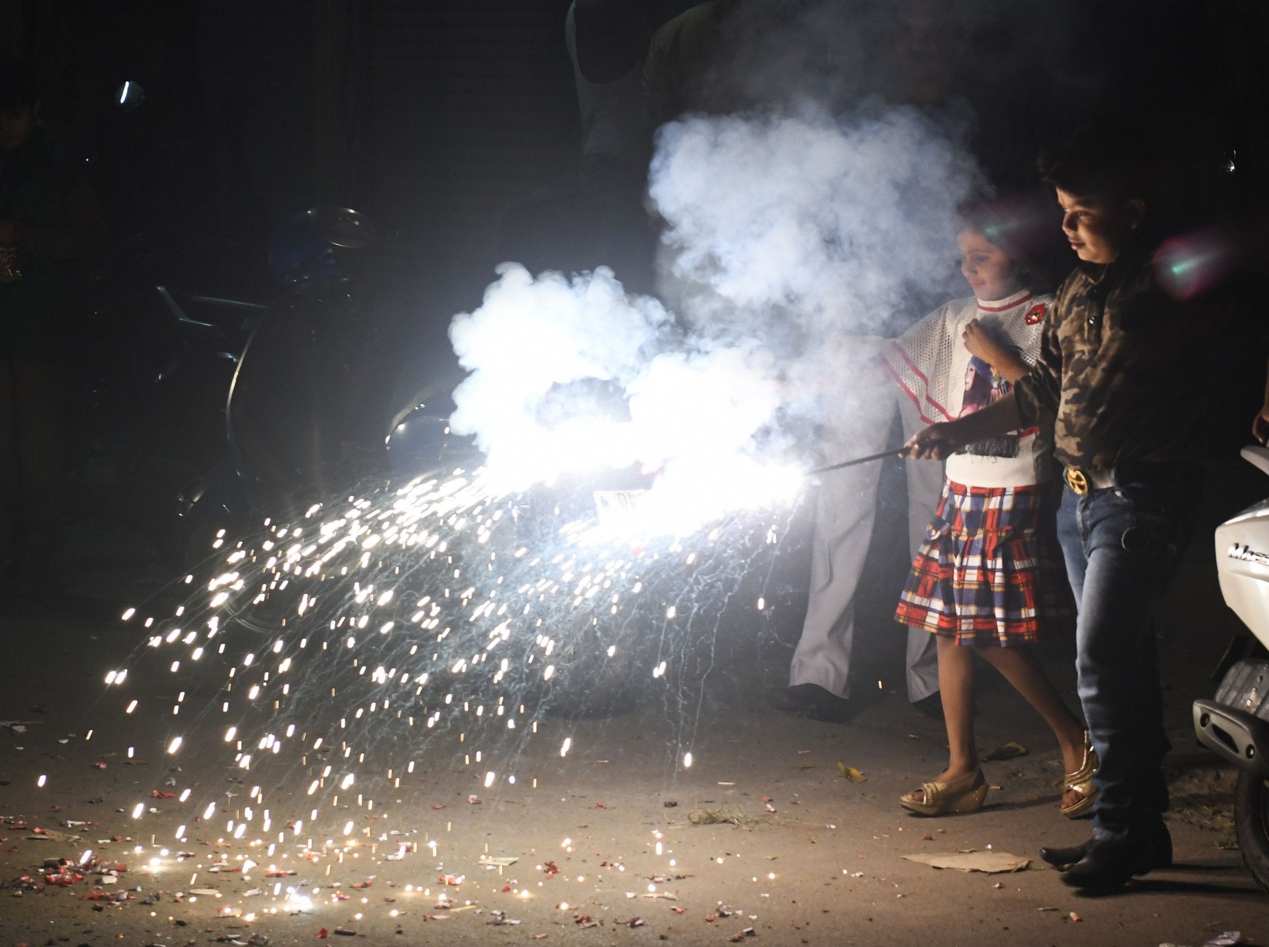 Indian children light firecrackers during Diwali festival