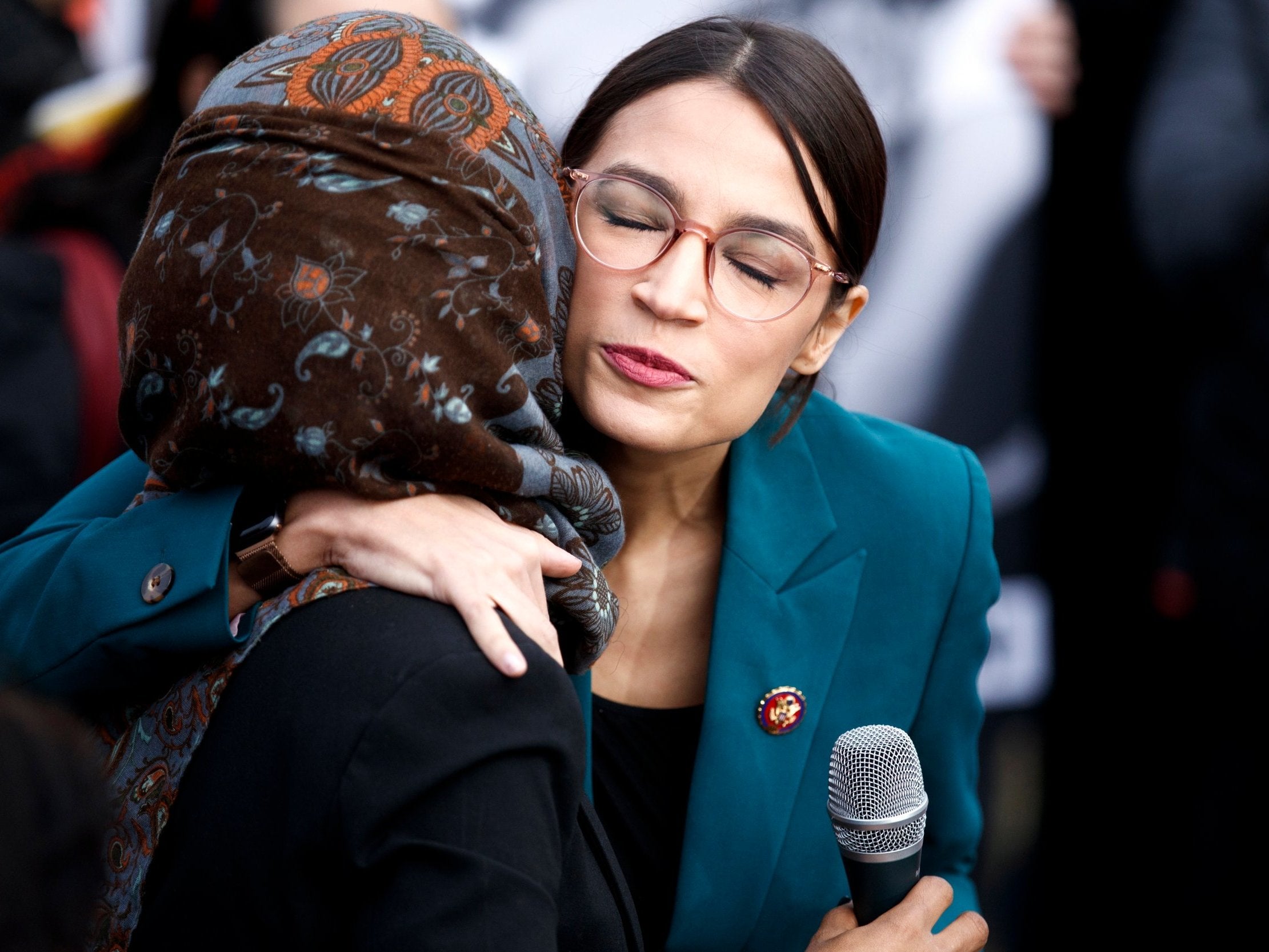 Ms Ocasio-Cortez embraces Ms Omar during a press conference in February