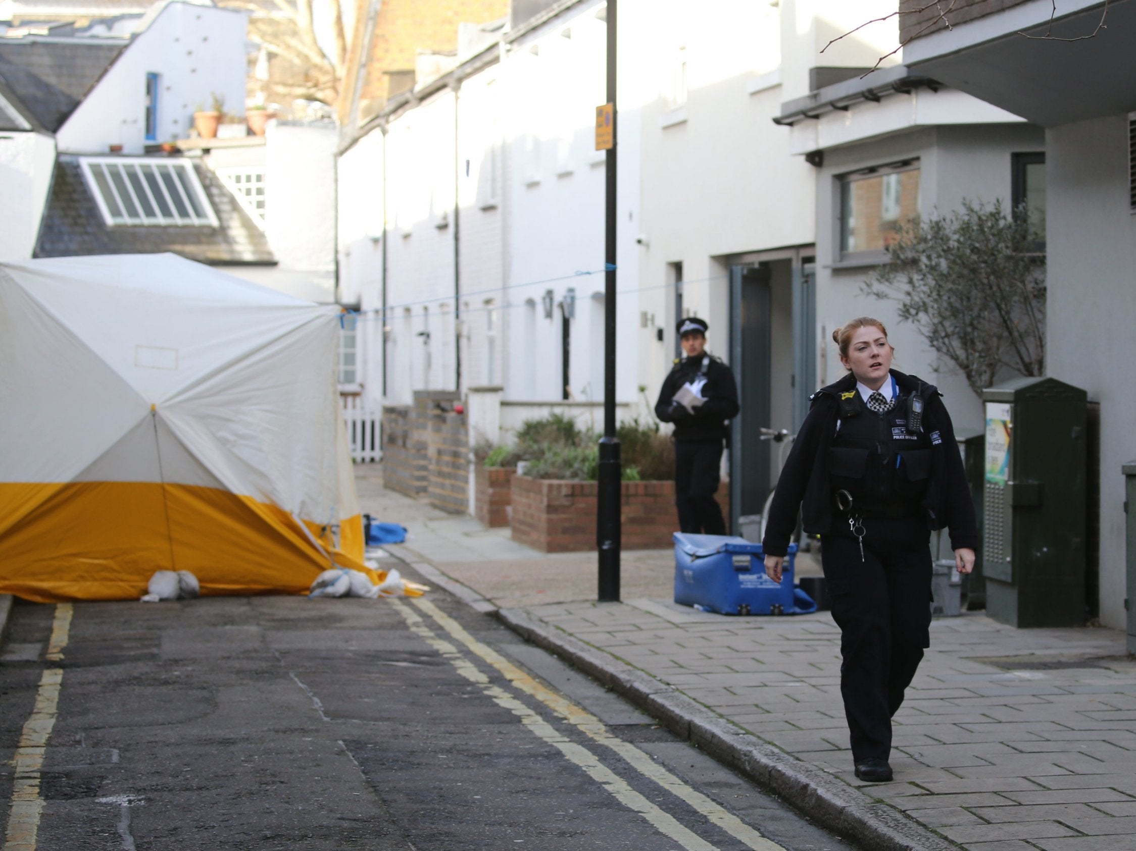 Police investigate the scene of the murder in Lanfrey Place, West Kensington, London