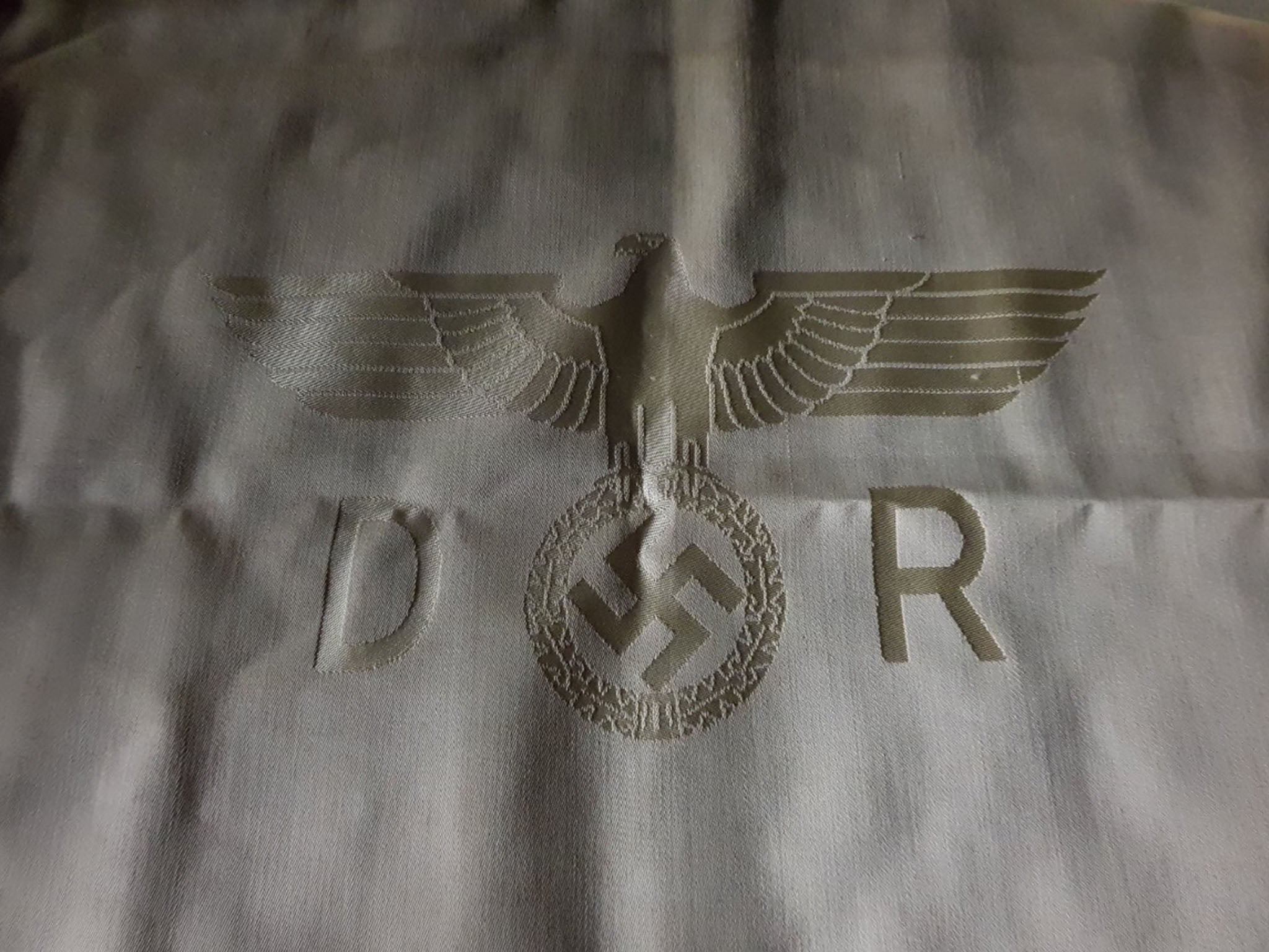 Described as 'historically rare', the tablecloth, napkins and silver cutlery set are emblazoned with swastikas.