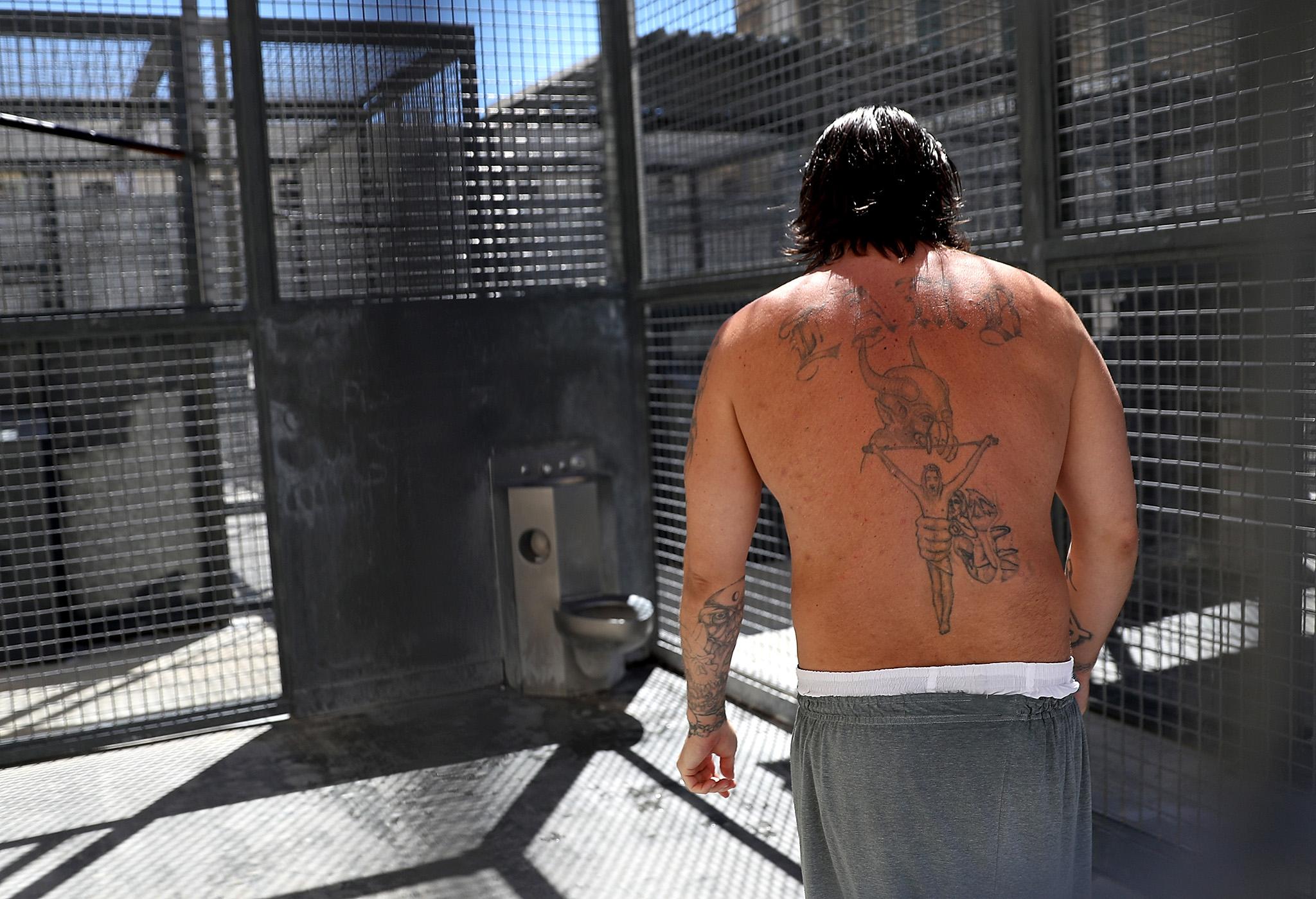 A condemned inmate stands in a cell out in the yard of San Quentin prison