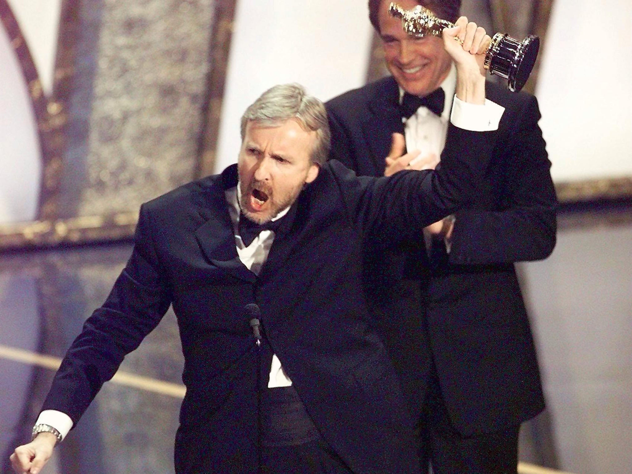 James Cameron raises his Oscar after winning Best Director for Titanic at the 70th Academy Awards in 1998 (AFP/Getty Images)