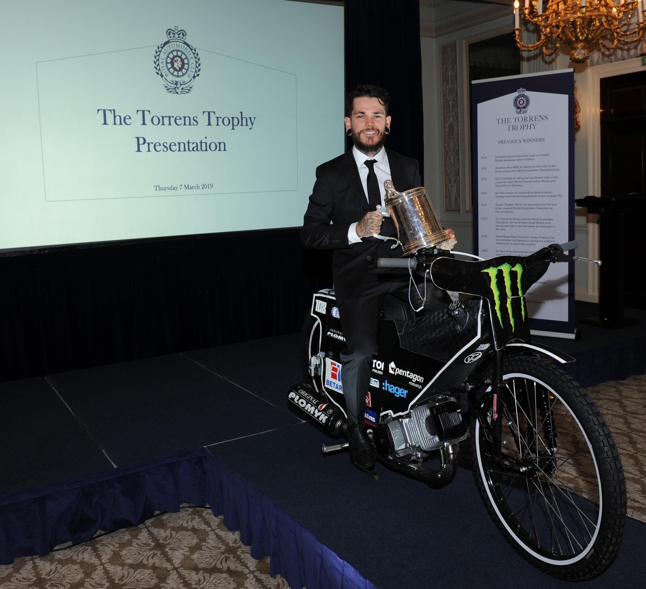 Woffinden poses with his award at the Pall Mall clubhouse in London