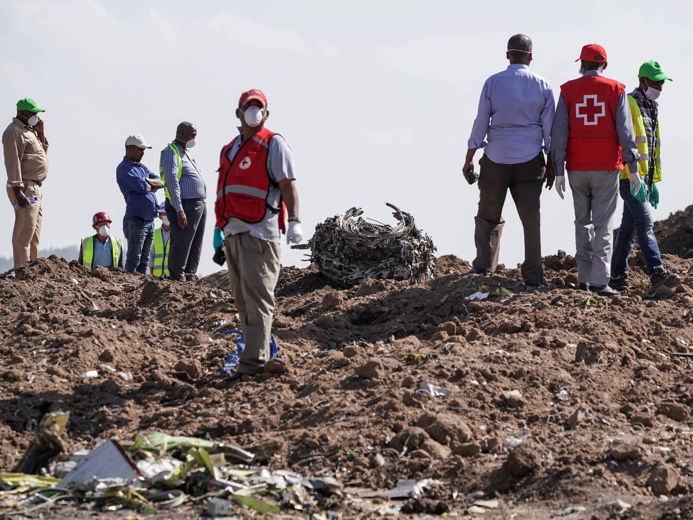 Recovery workers inspect an engine after it was recovered from the scene near Addis Ababa this week