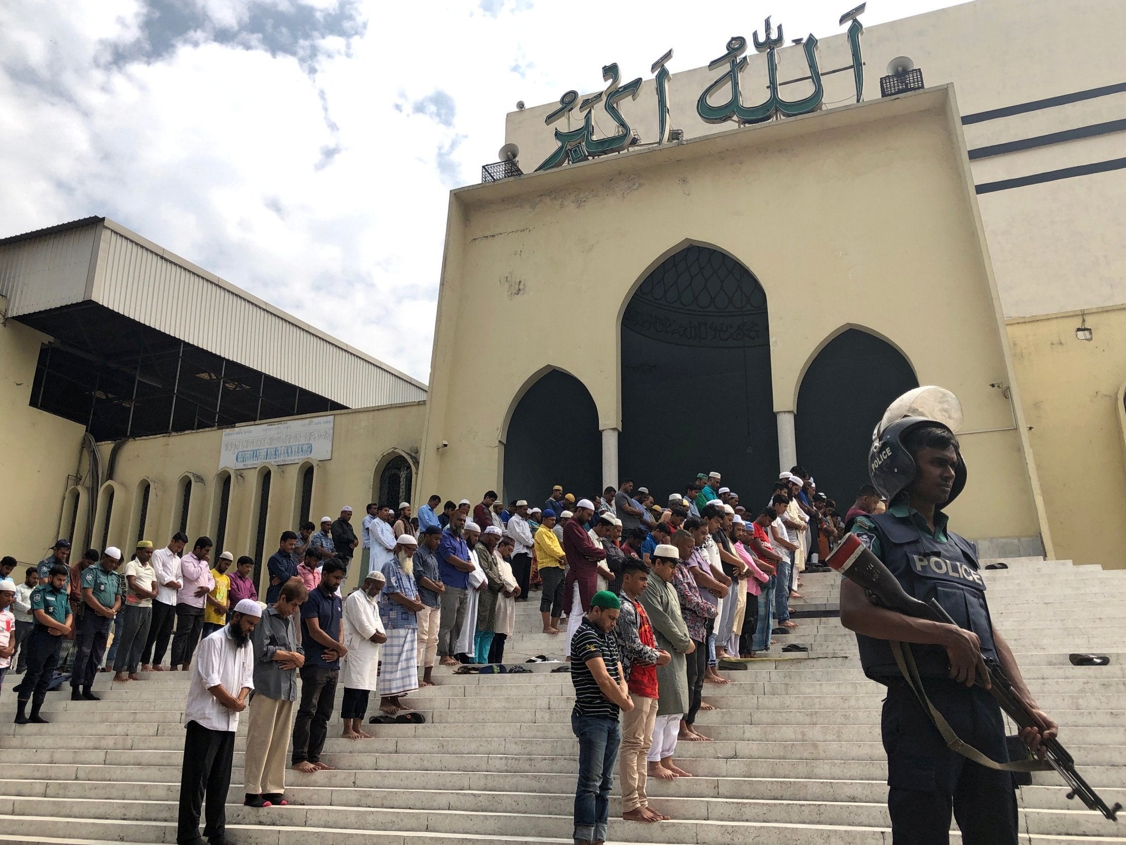 A police officer stands guard during Friday prayers at the Baitul Mukarram National Mosque, in Dhaka, Bangladesh, after the Christchurch mosque attacks in New Zealand (Reuters)